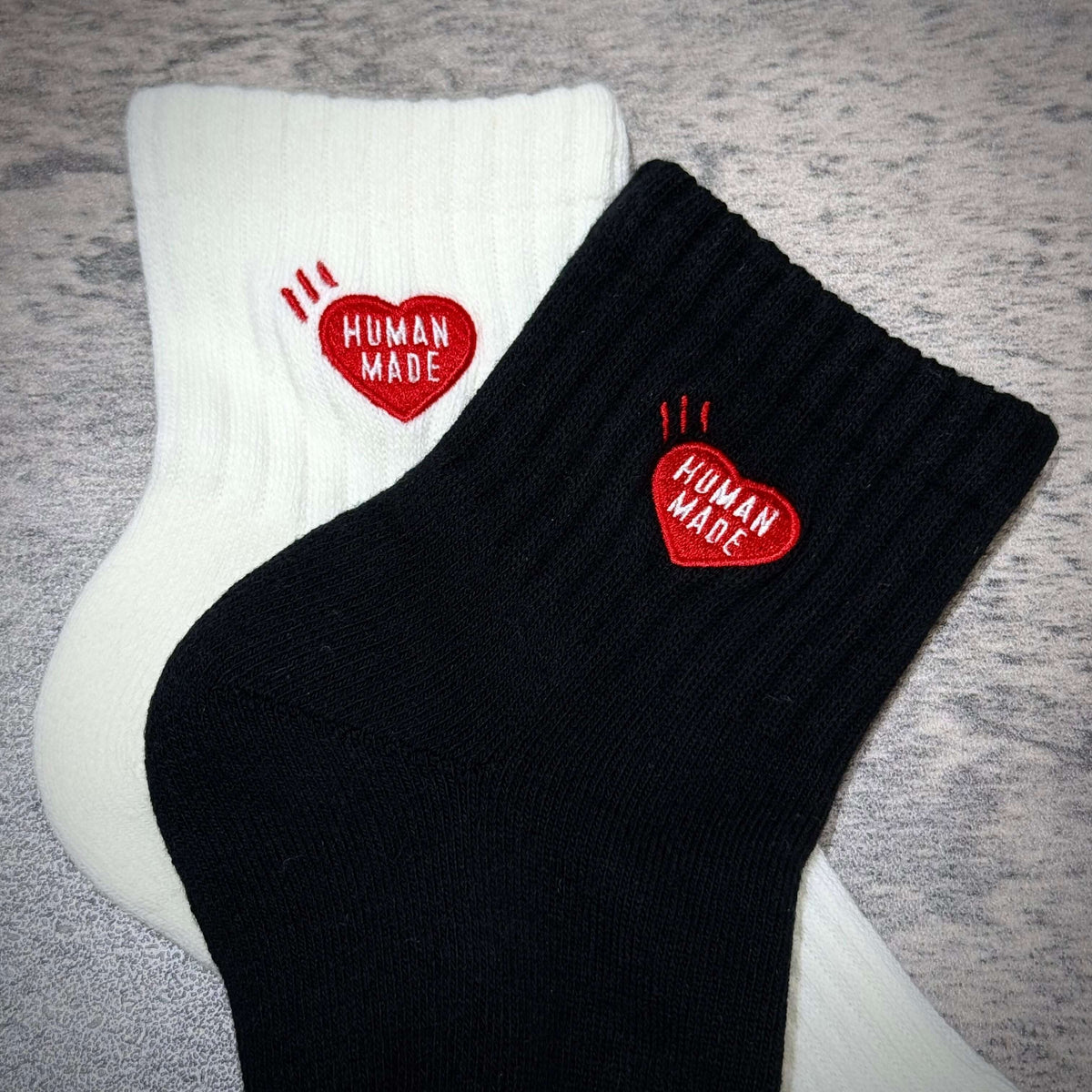 Human Made Pile Short Socks HM00GD009 featuring black and white color variations with heart logo.