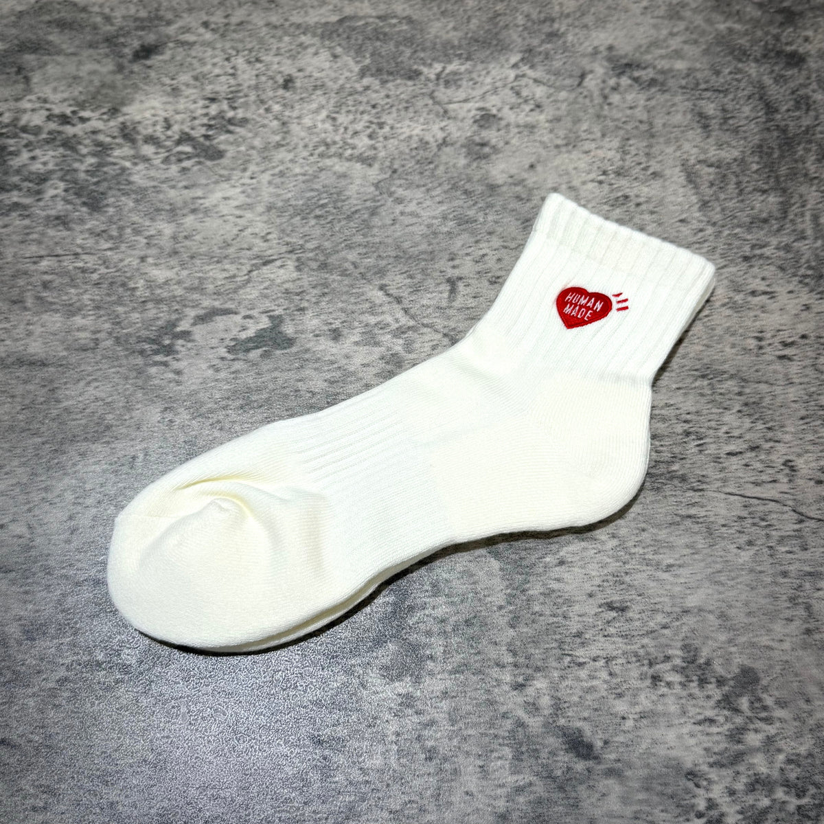 Human Made Pile Short Socks HM00GD009 on a textured surface showcasing its unique design.