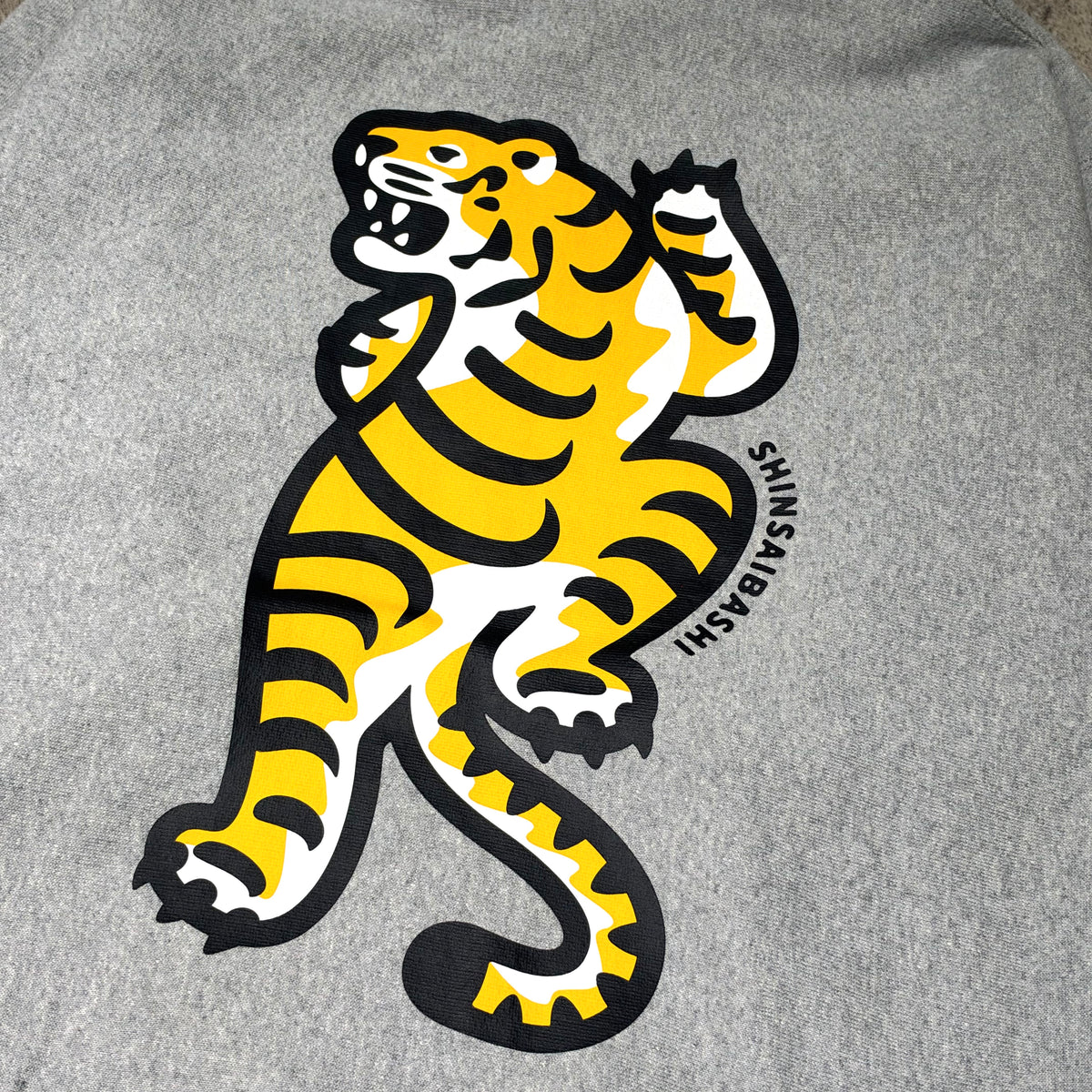 Human Made Shinsaibashi Exclusive Tiger Heavyweight Hoodie featuring a bold tiger graphic on a gray background.