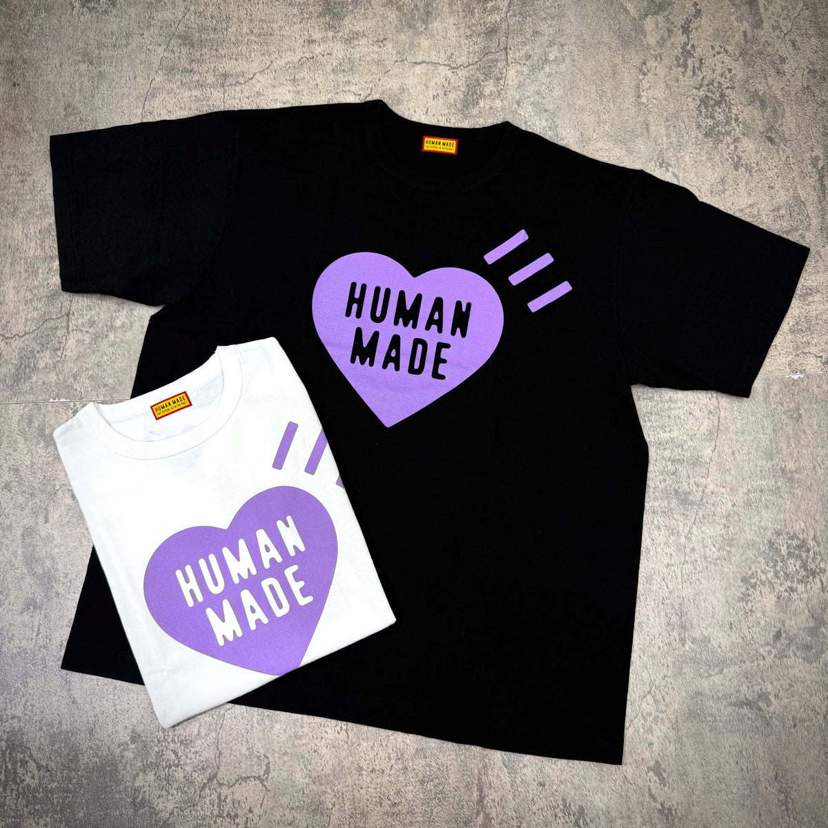 Human Made Apgujeong Exclusive Heart Logo Tee in black and white with heart design.