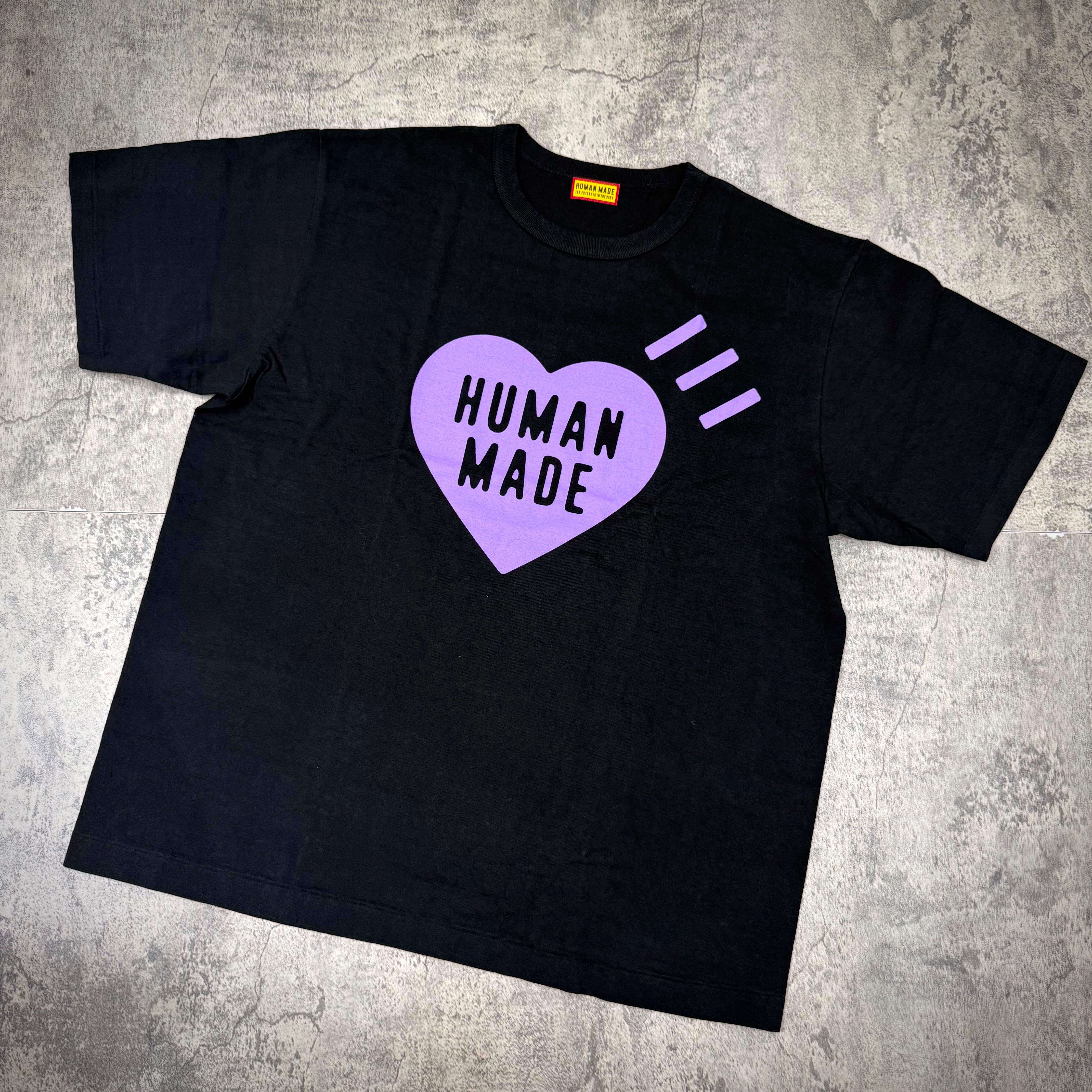 Human Made Apgujeong Exclusive Heart Logo Tee featuring a black shirt with purple heart design and text.