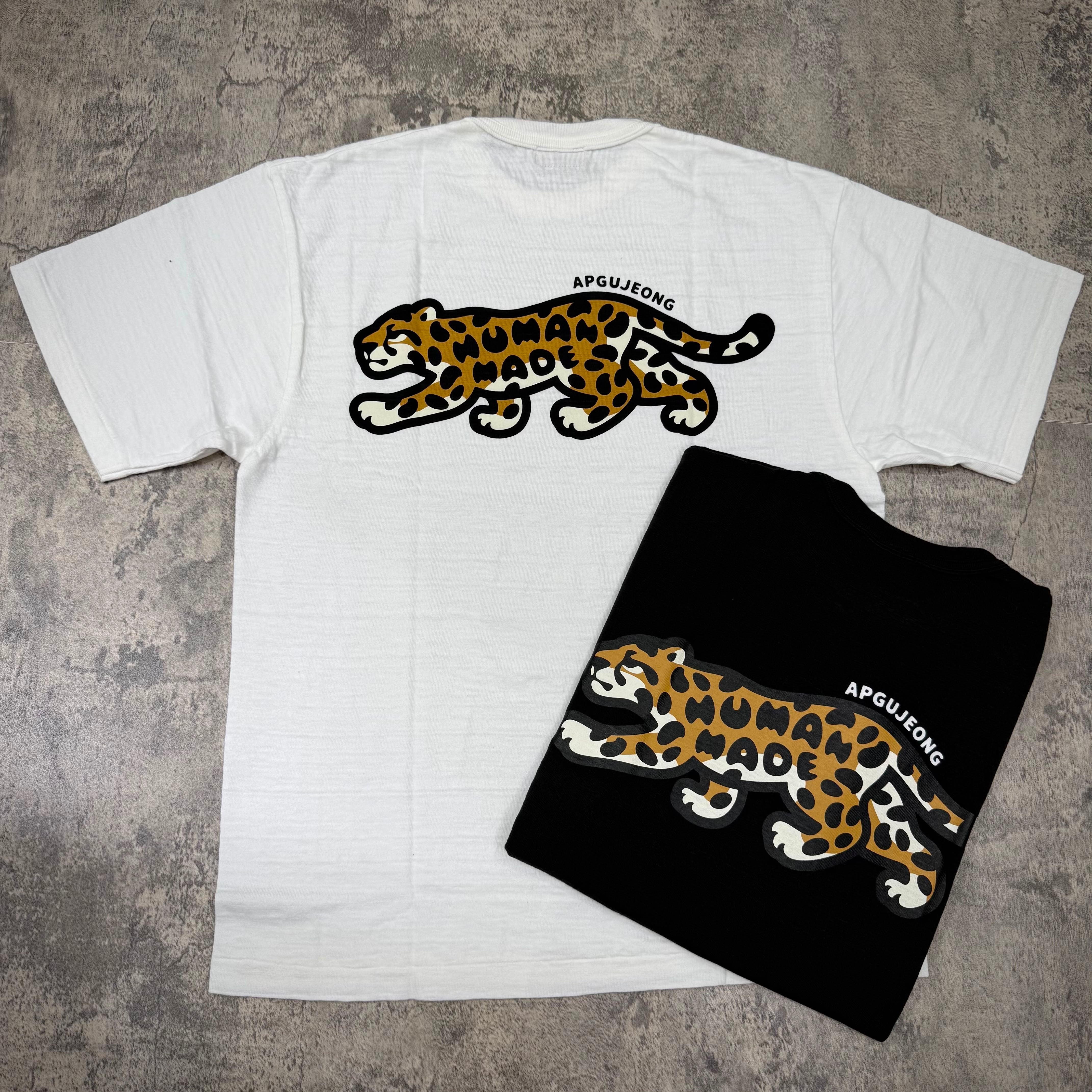 Human Made Apgujeong Exclusive Leopard Back Logo Tee featuring leopard design on white and black shirts.
