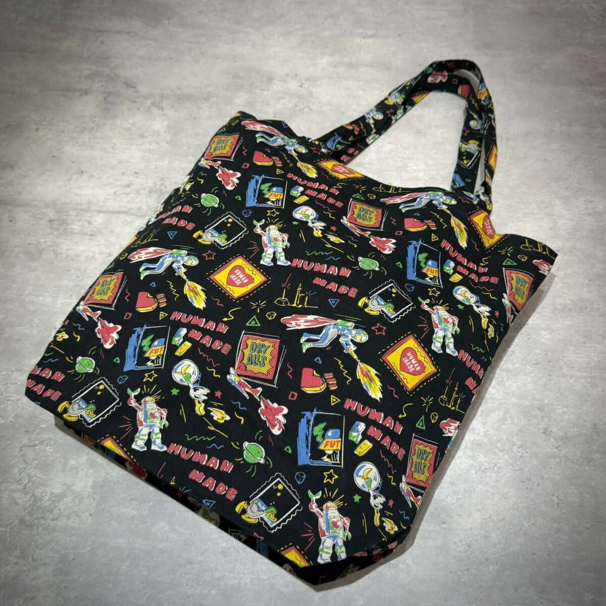 Colorful Human Made Book Tote with playful graphics and stylish design, perfect for carrying books and essentials.
