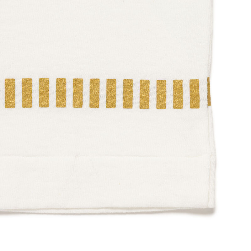 Close-up of the Human Made Cup Noodle Graphic Tee detailing, featuring a gold stripe pattern on white fabric.