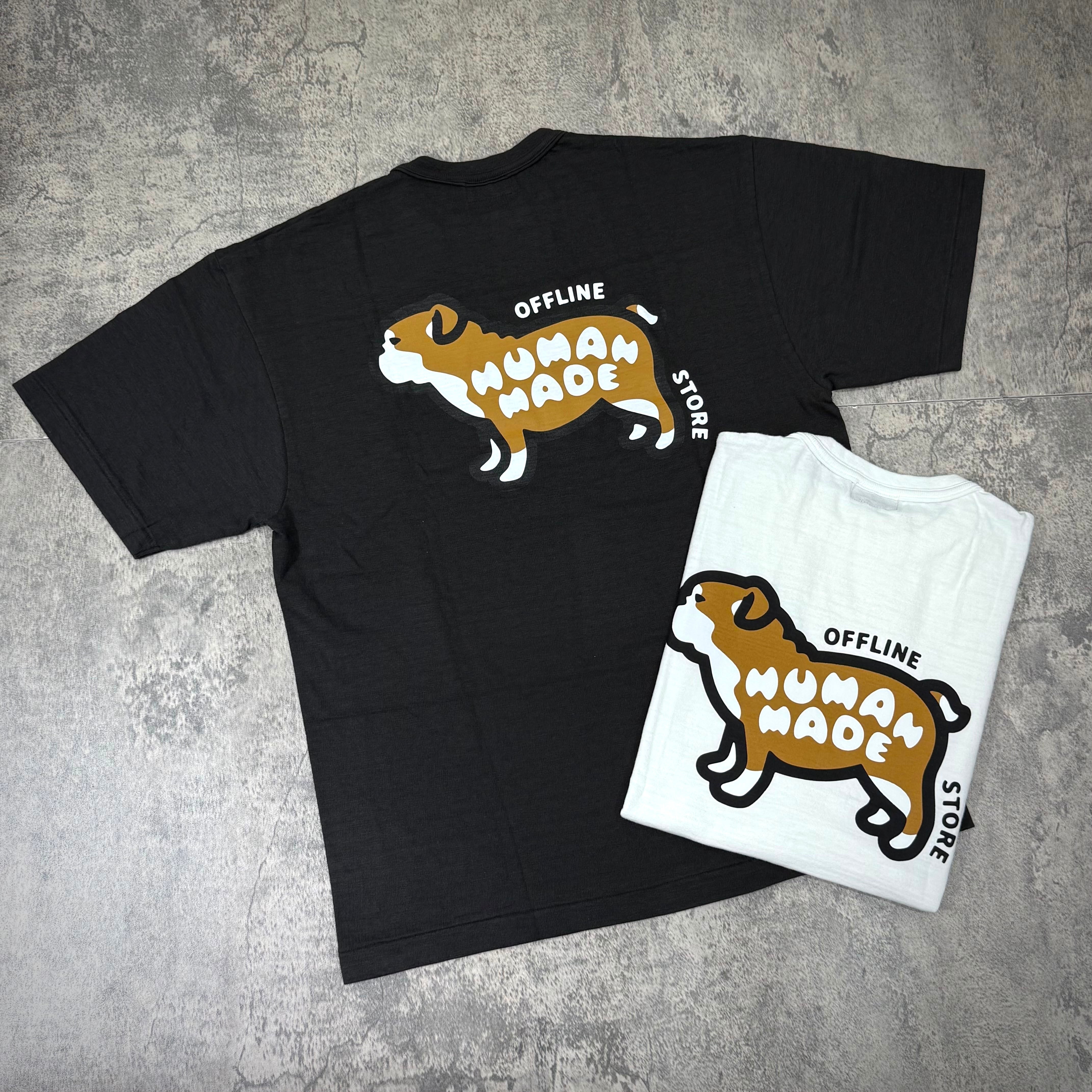 Human Made Gaien offline Exclusive Bull Dog Back Logo Tee displayed in black and white colors on a textured background.