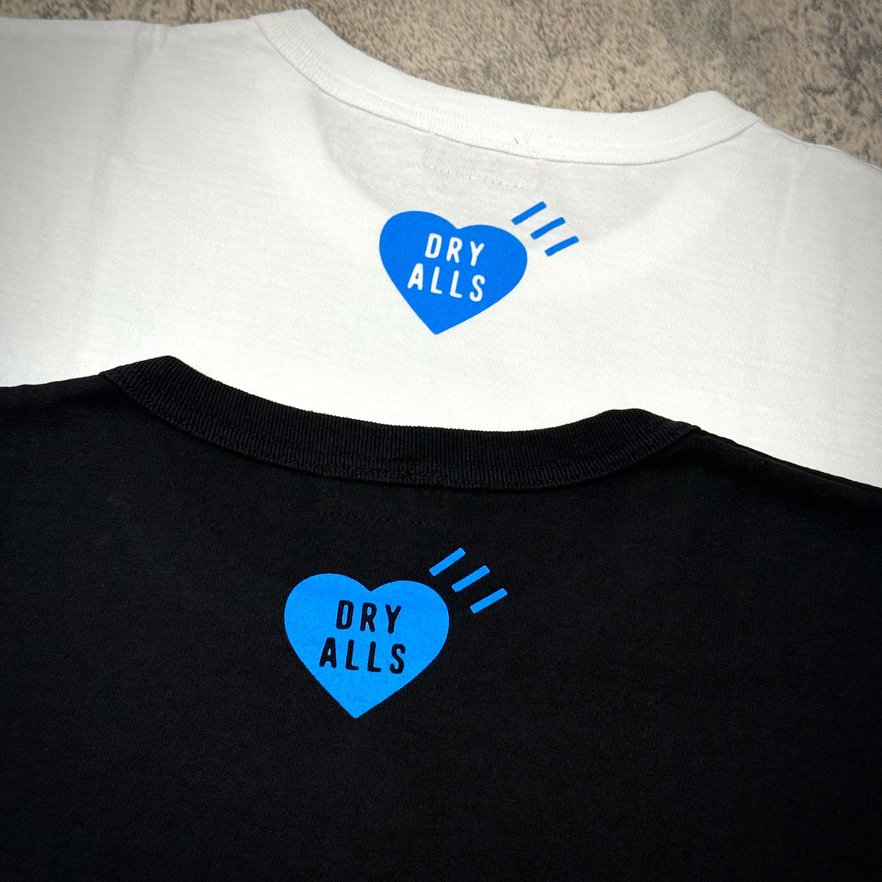 Human Made Gaien offline Exclusive Heart Logo Tee showing white and black t-shirts with blue heart logo and "DRY ALLS" text.
