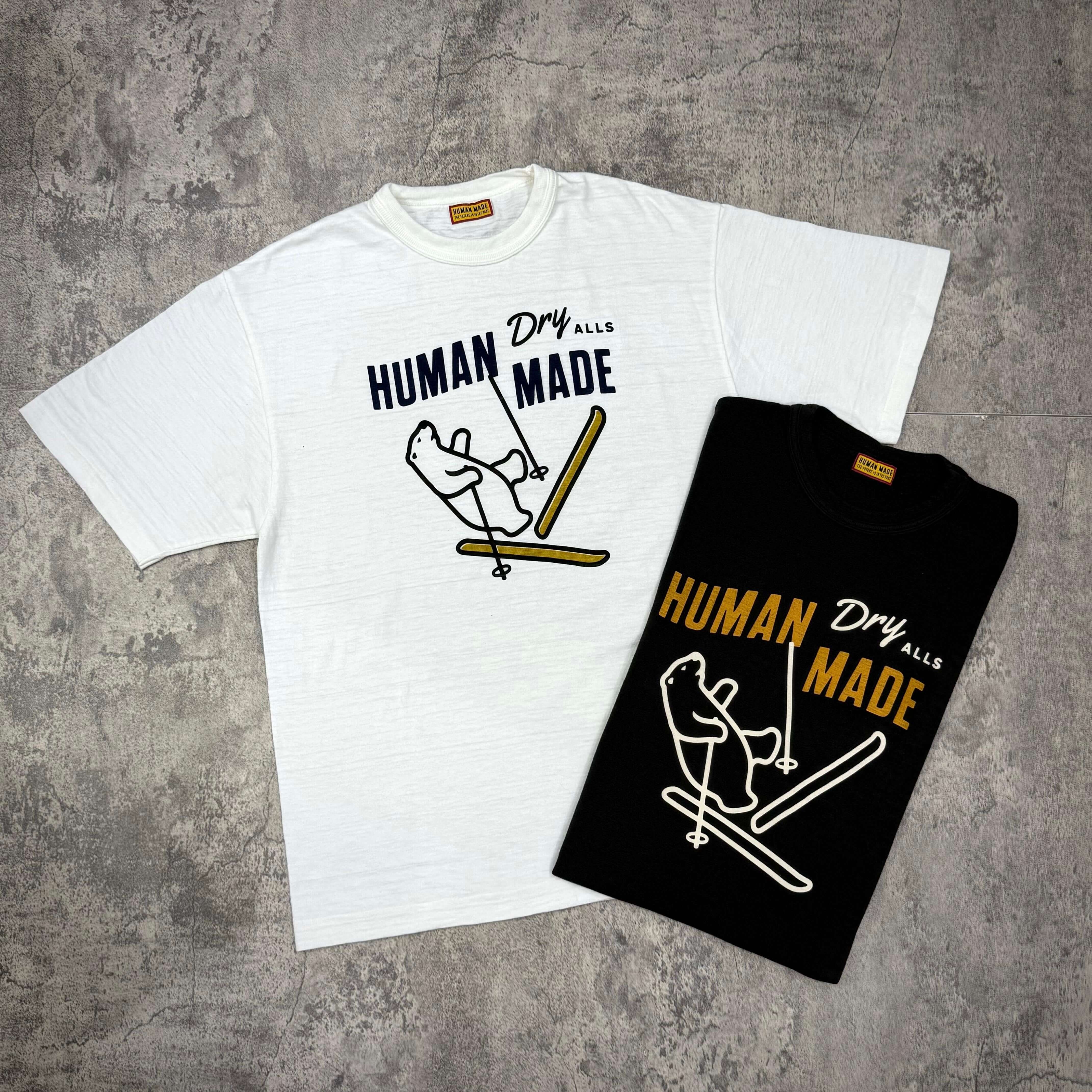 現貨 Human Made Graphic Tee HM30TE010 - Black / White,展示兩款T恤,白色和黑色,印有Human Made圖案。