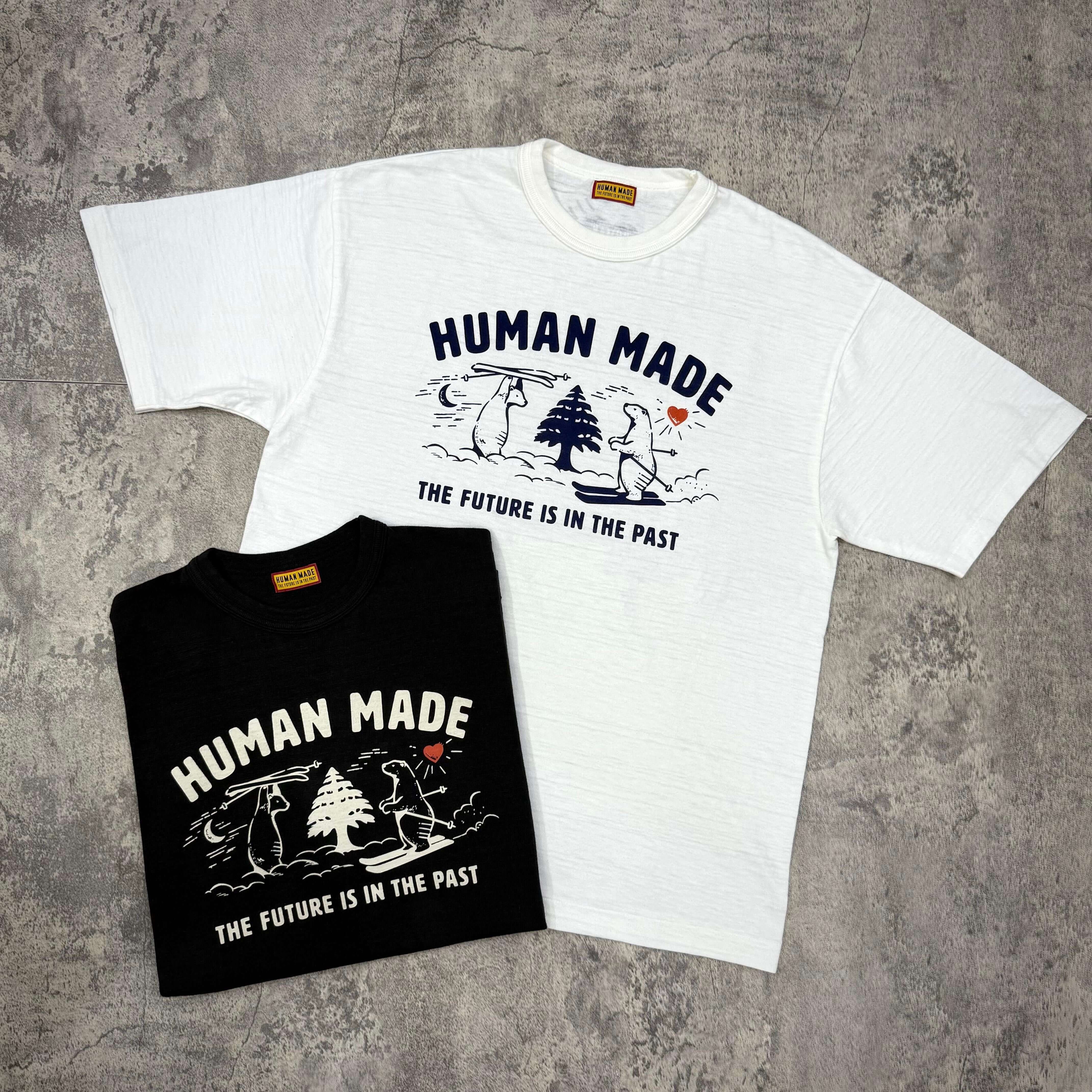 Human Made Graphic Tee HM30TE016 - Black and White shirts featuring graphic designs and text "THE FUTURE IS IN THE PAST".