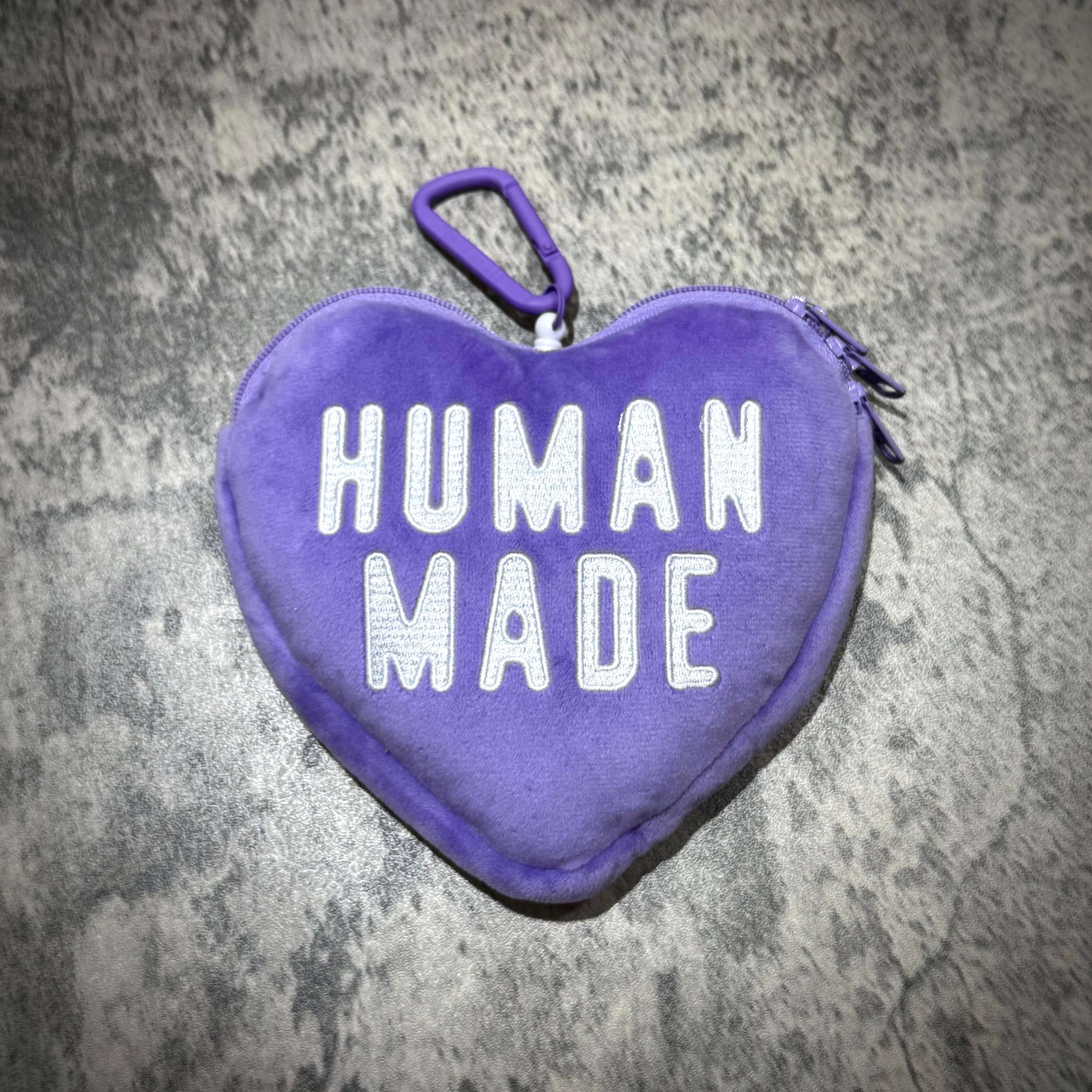 Human Made Heart Pass Case in purple with white lettering on textured background.