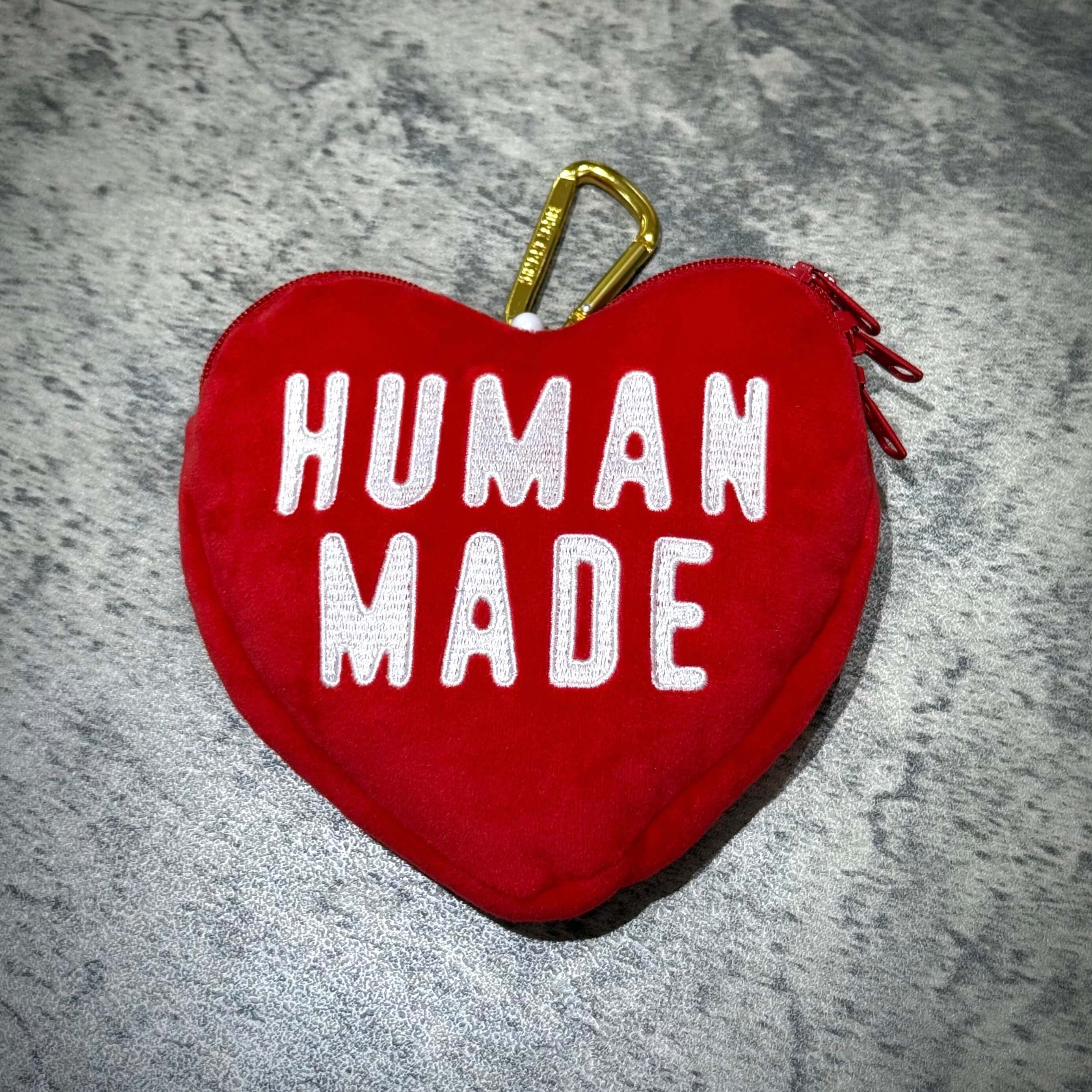 Human Made Heart Pass Case in red with white lettering on a textured surface.
