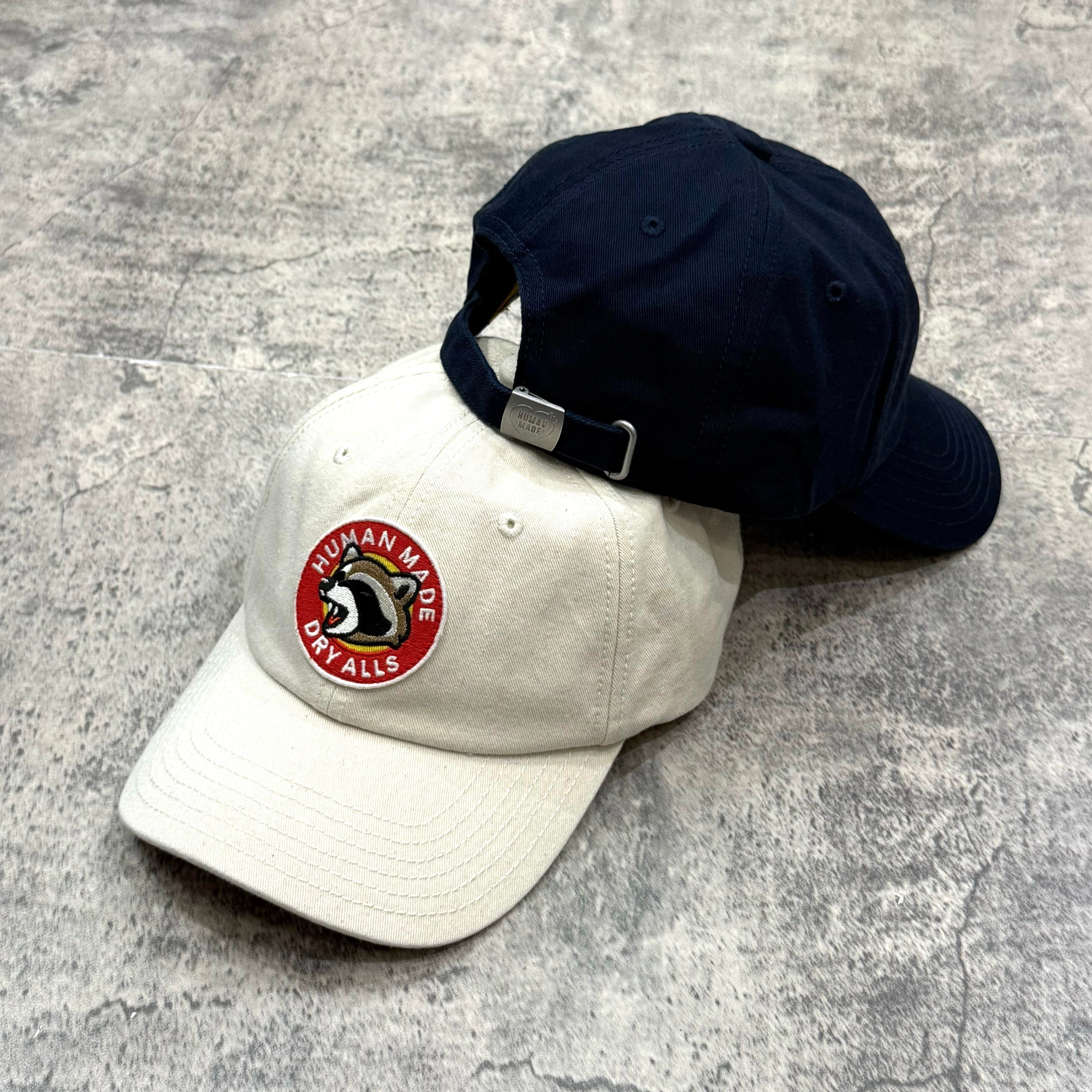 Human Made Jamsil Exclusive 6 Panel Twill Raccon Cap displayed in white and navy color options.