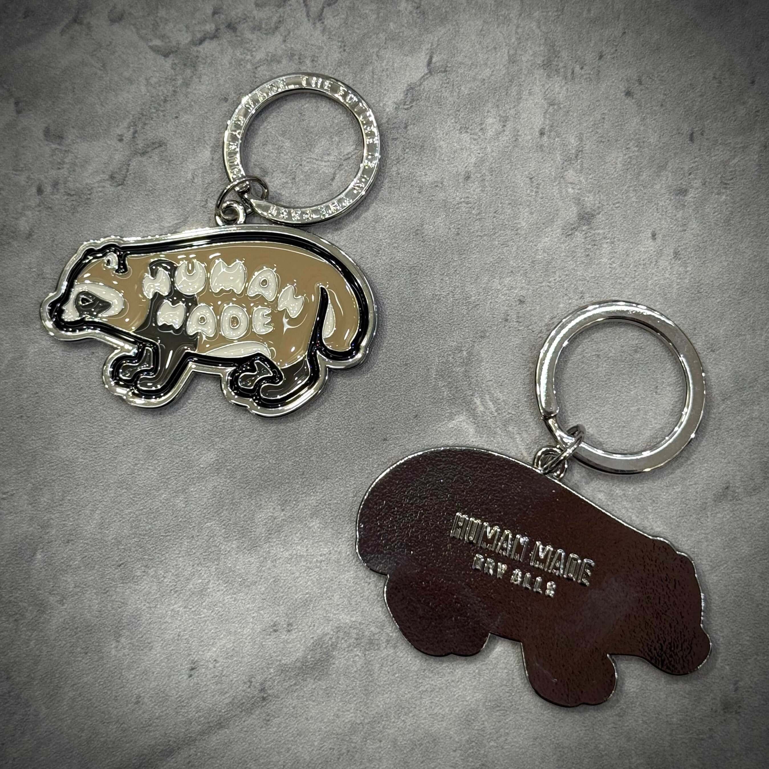 Human Made Jamsil Exclusive Raccon Keychain displayed on a textured surface, showcasing unique designs.