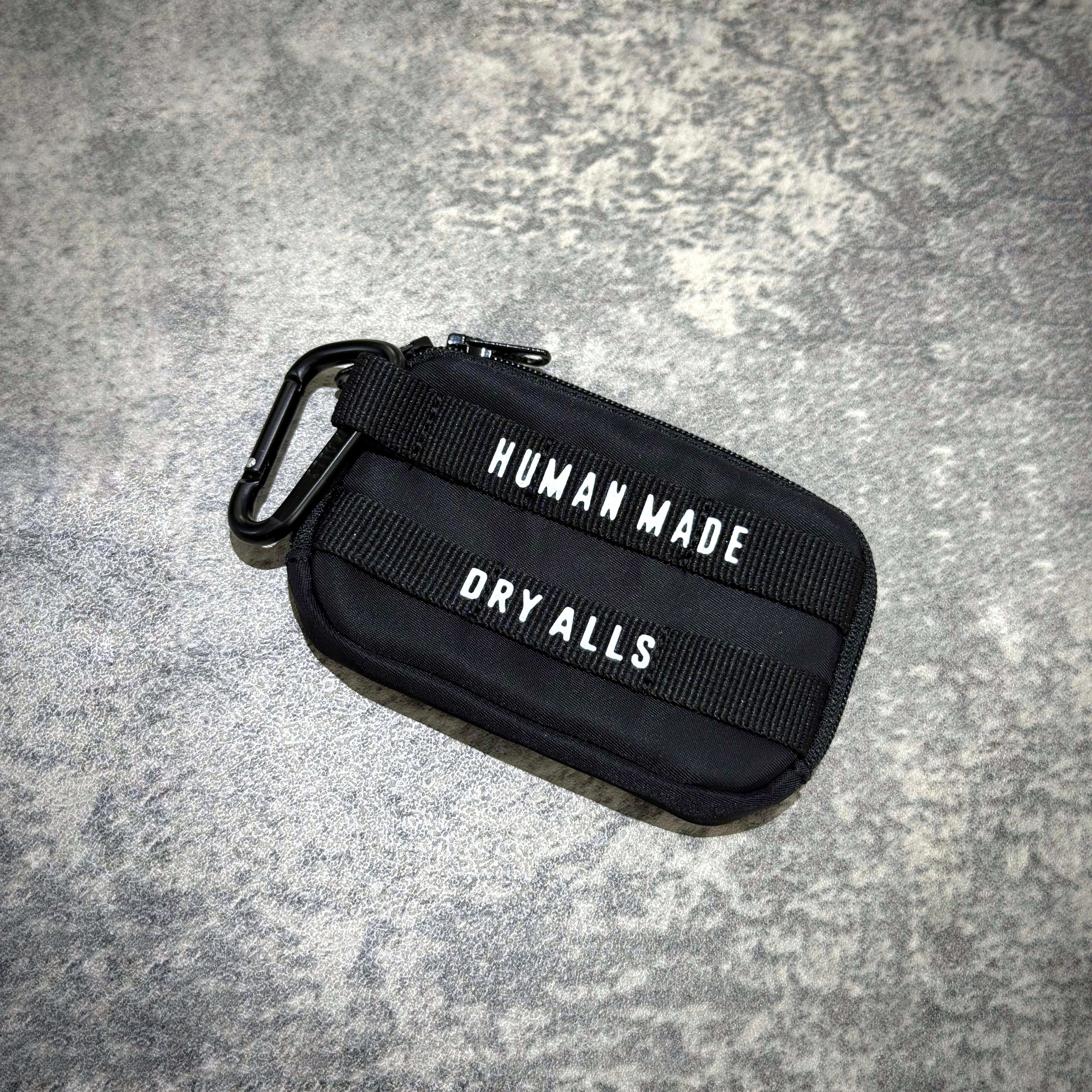 Human Made Military Card Case in black with durable straps, featuring 'HUMAN MADE' and 'DRY ALLS' text.