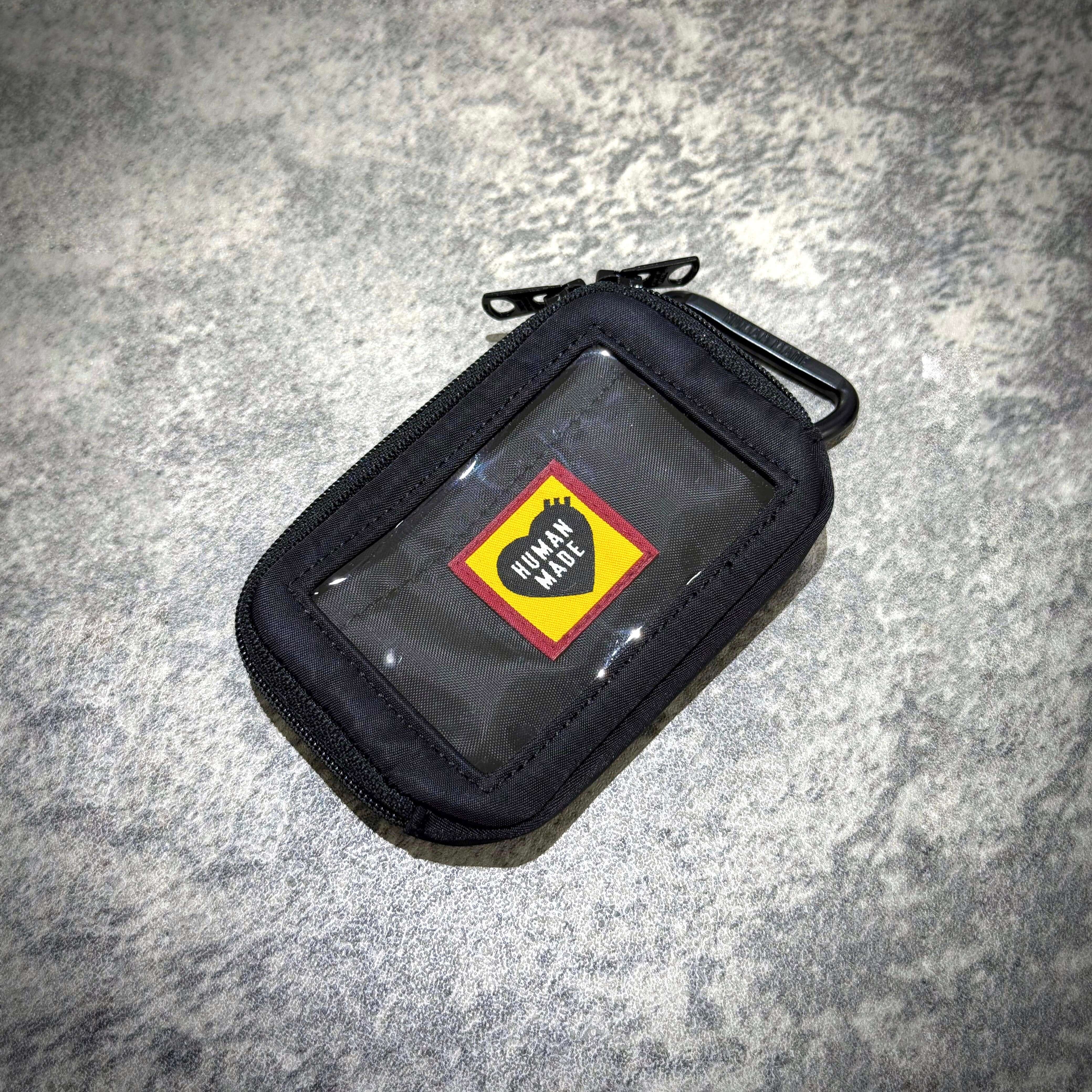 Human Made Military Card Case featuring a sleek design with a transparent window and logo.