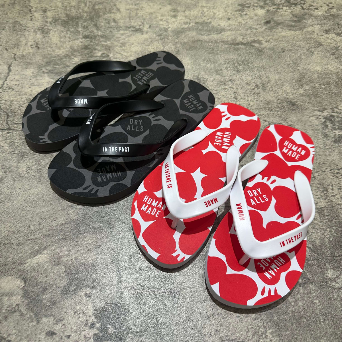 Human Made Beach Sandal 的黑色和紅色拖鞋,印有獨特圖案,適合夏日穿著。