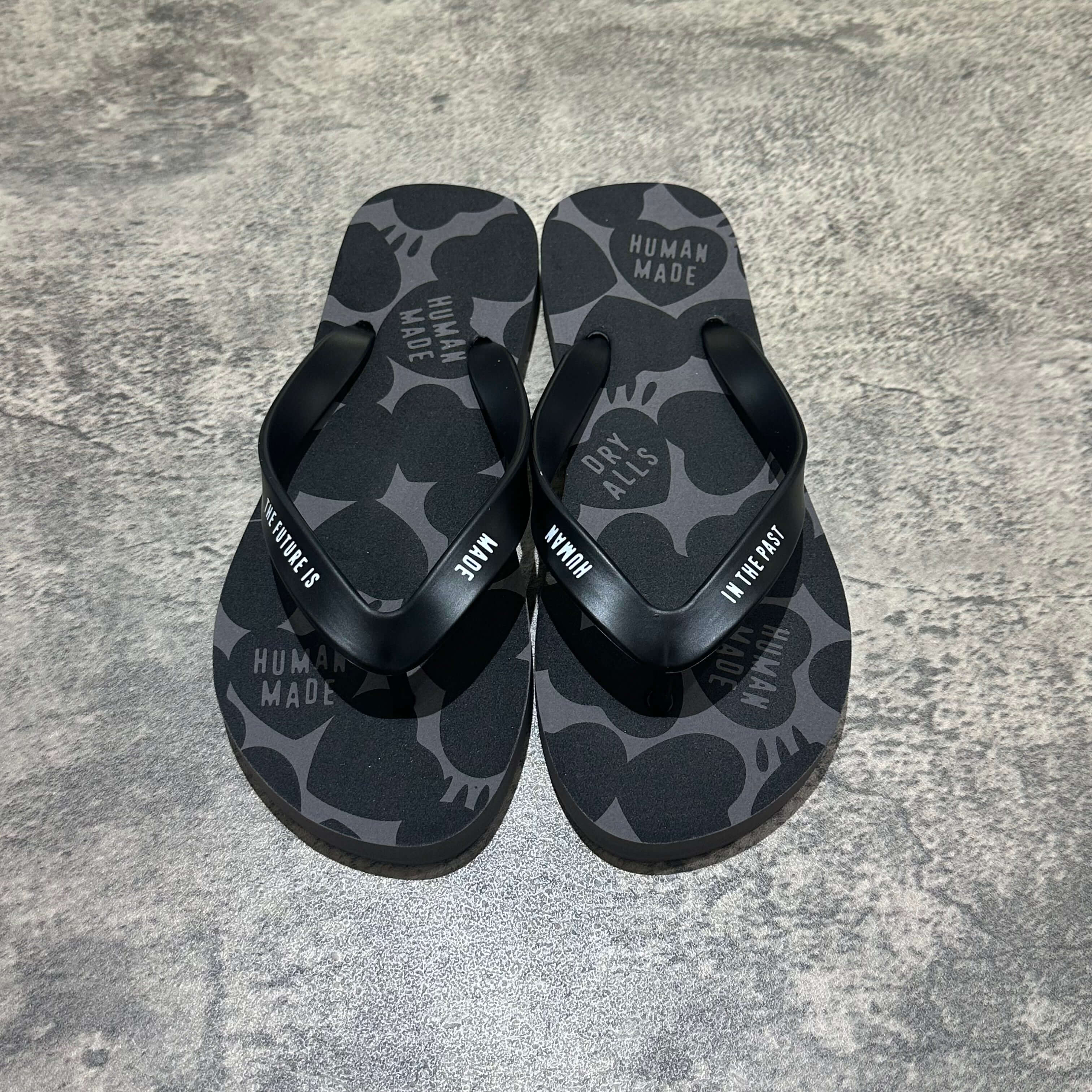 Human Made Sandal featuring a black and gray pattern with a flip-flop design on a textured background.