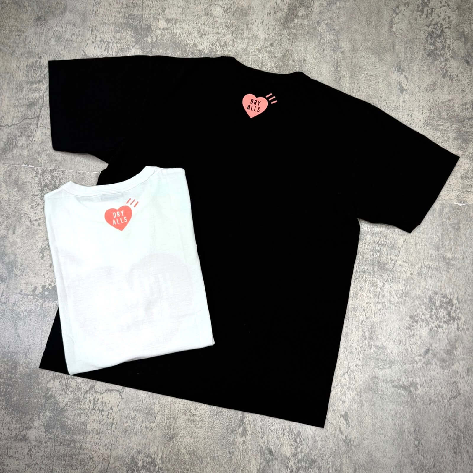 Human Made Seoul Exclusive Heart Logo Tee in black and white, showcasing heart logo on back.