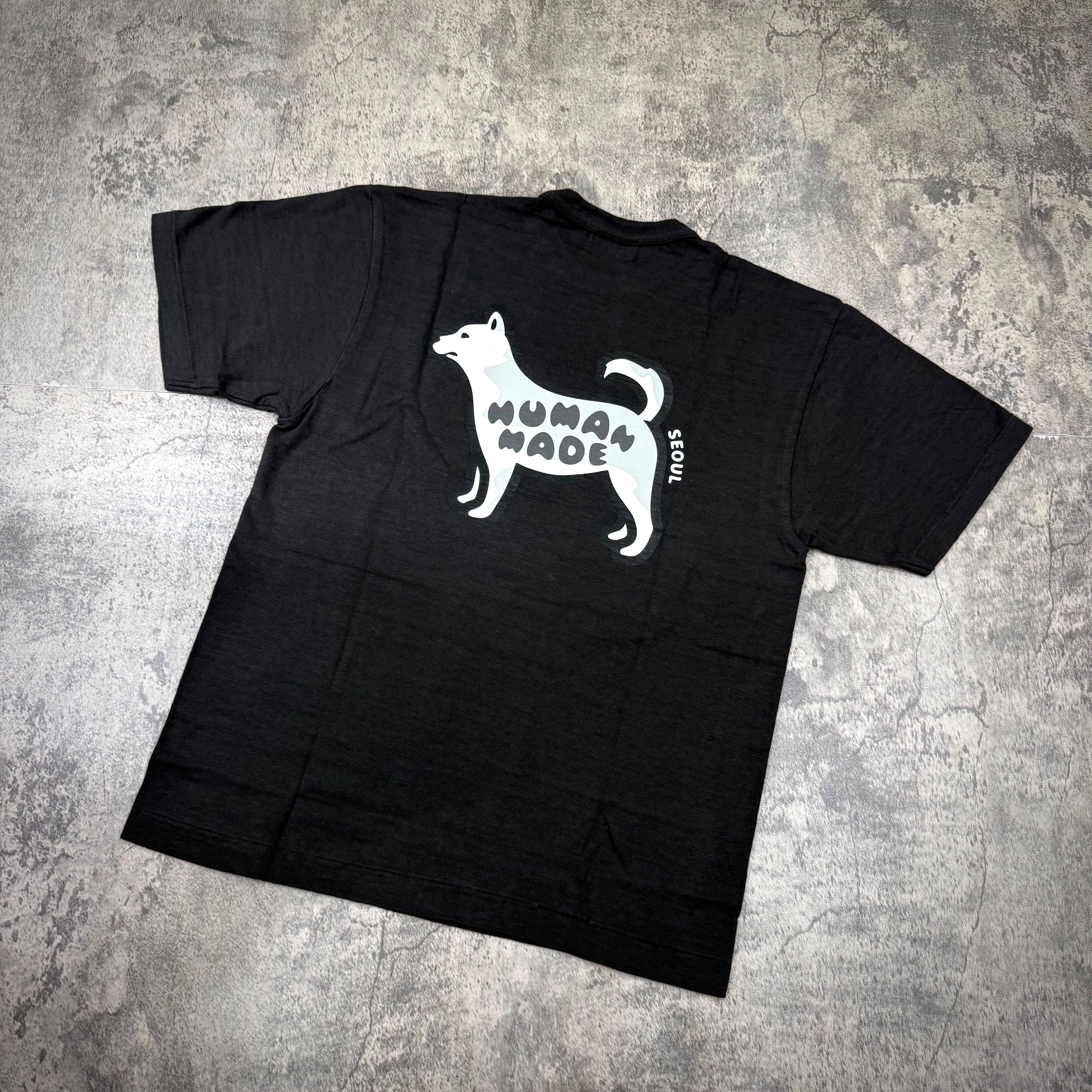 Human Made Seoul Exclusive Jindo Dog Back Logo Tee featuring a black shirt with dog graphic and 'HUMAN MADE' text.
