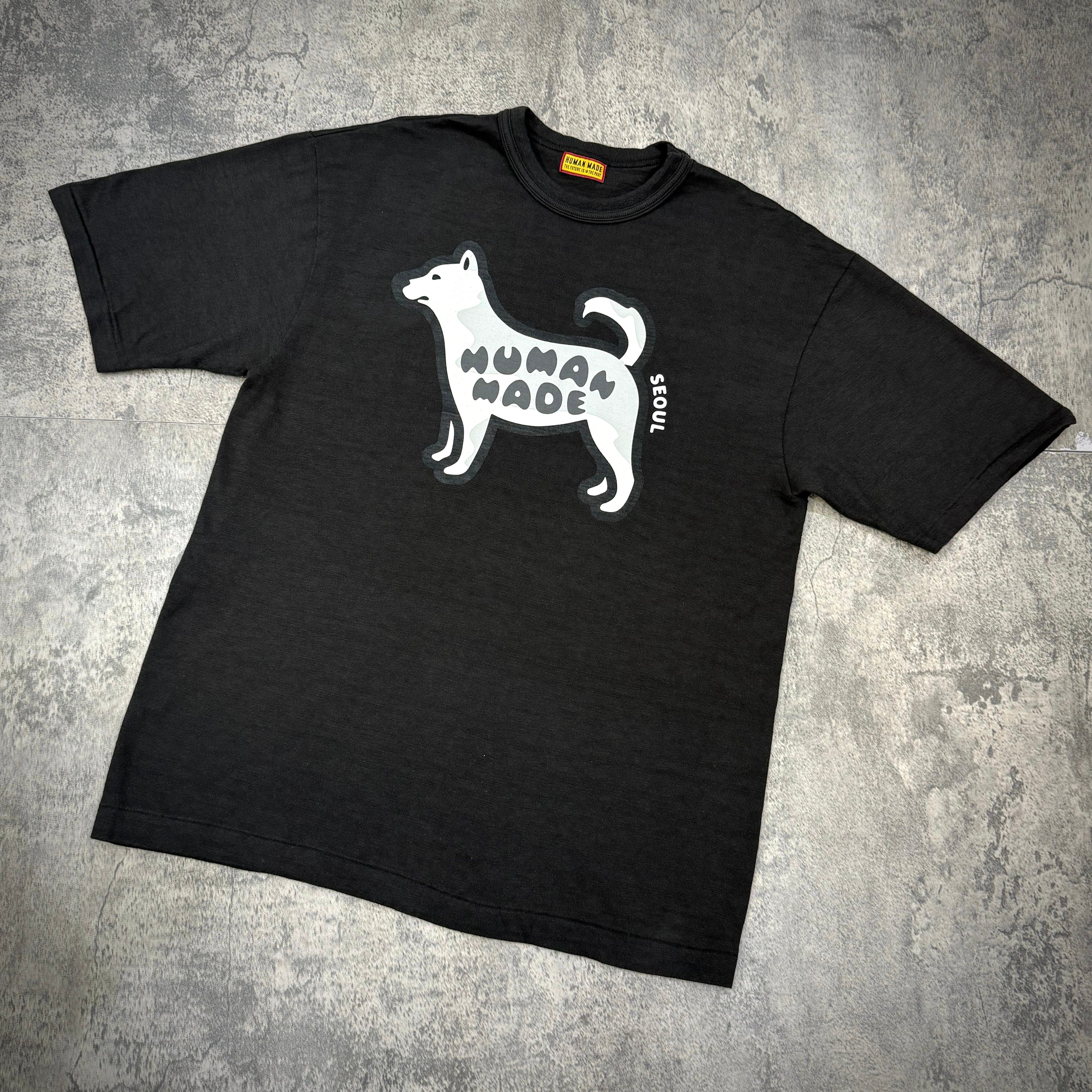 Human Made Seoul Exclusive Jindo Dog Tee featuring a playful dog graphic on a dark t-shirt.