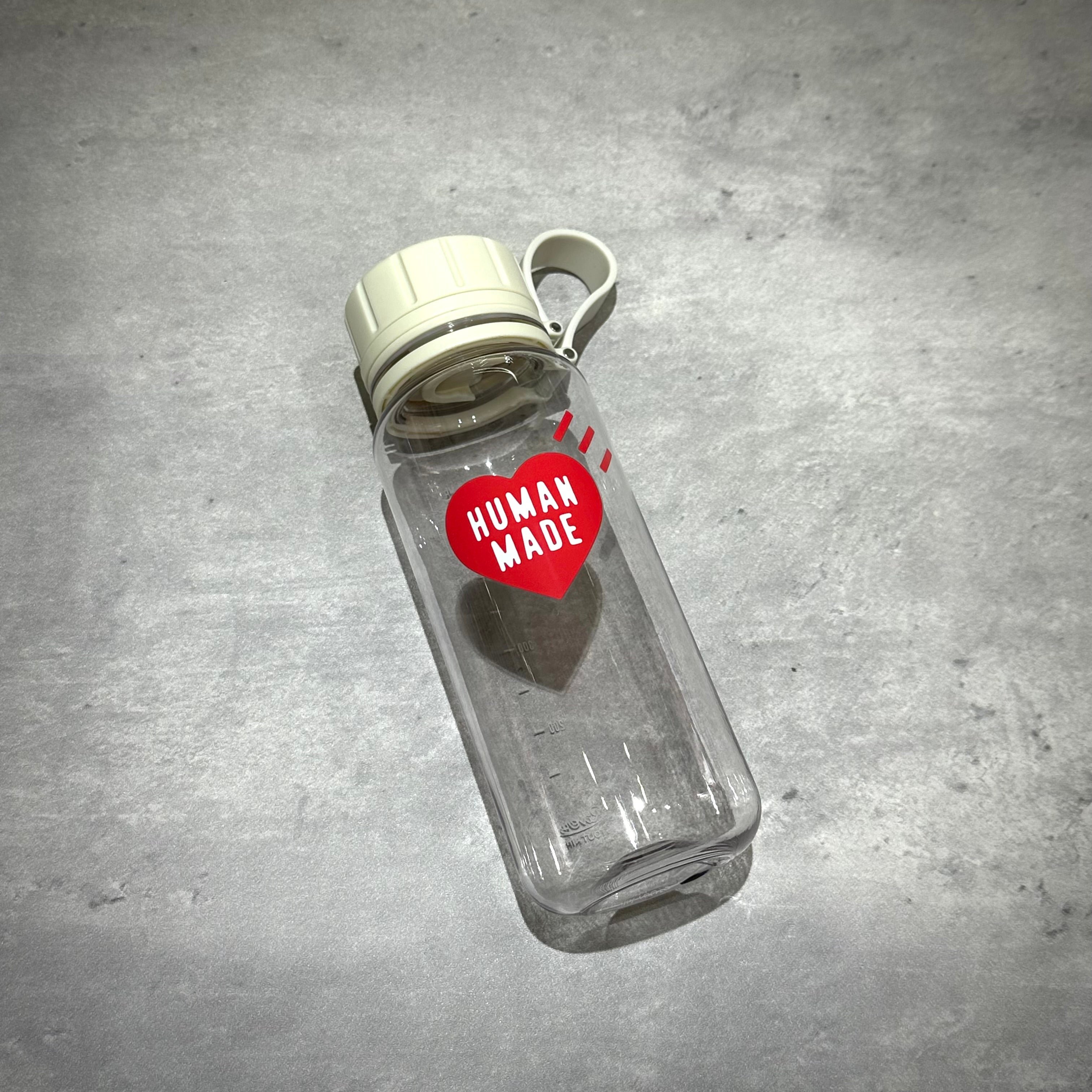 Human Made Water Bottle with a heart logo on a clear design, perfect for hydration on the go.