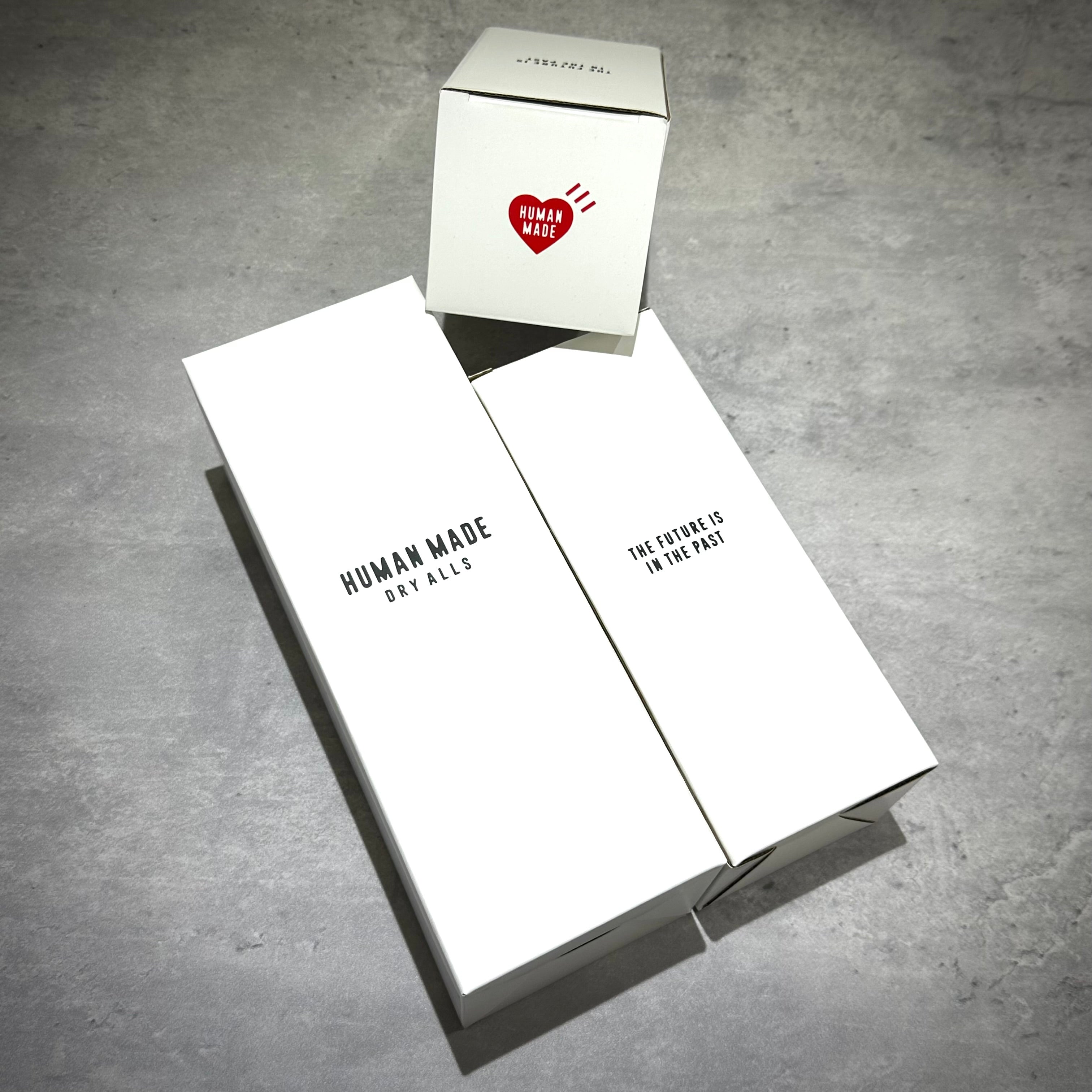 Human Made Water Bottle packaging boxes on a concrete surface.