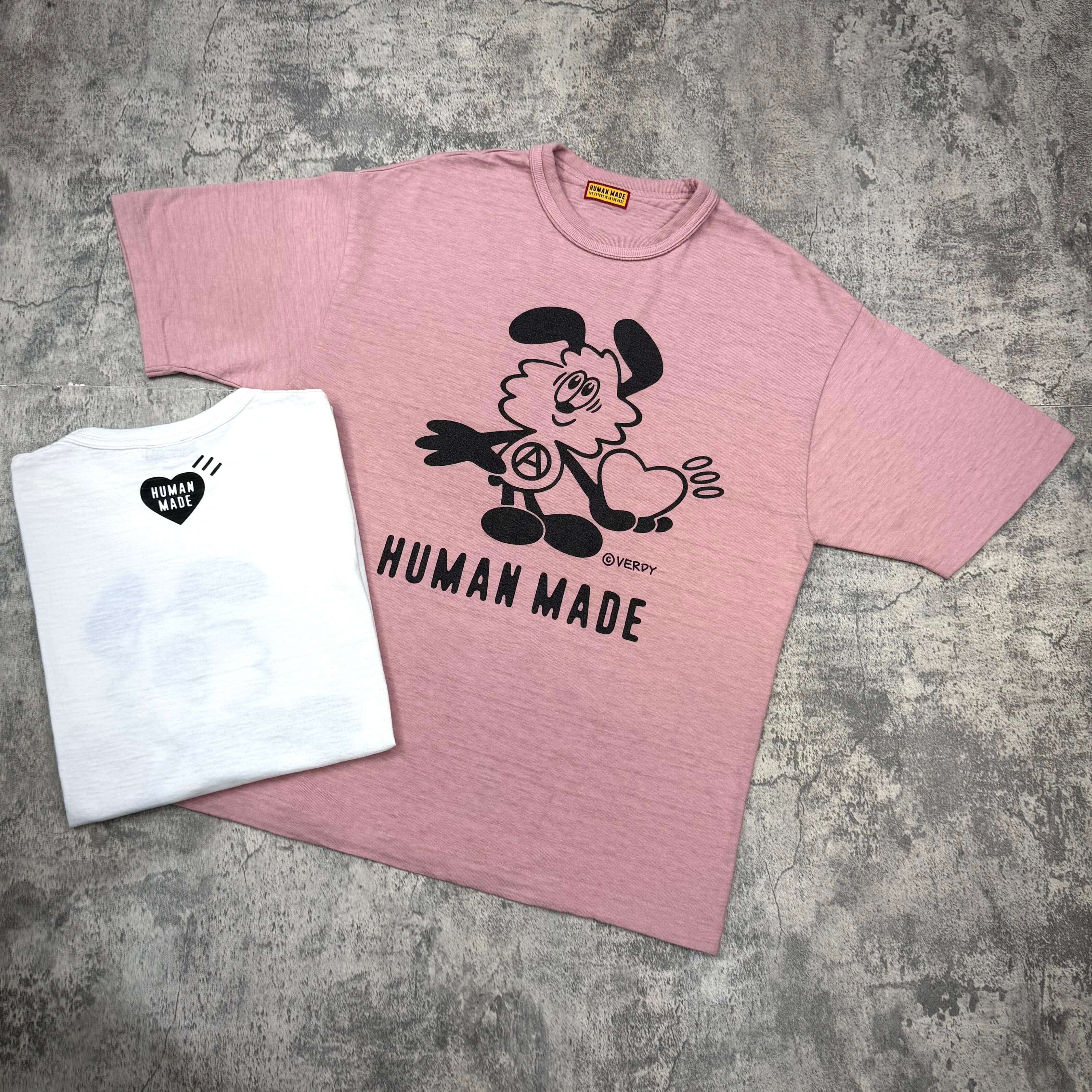 Human Made x VERDY Jamsil Exclusive Vick Tee in pink color with cartoon graphic and white tee in background.