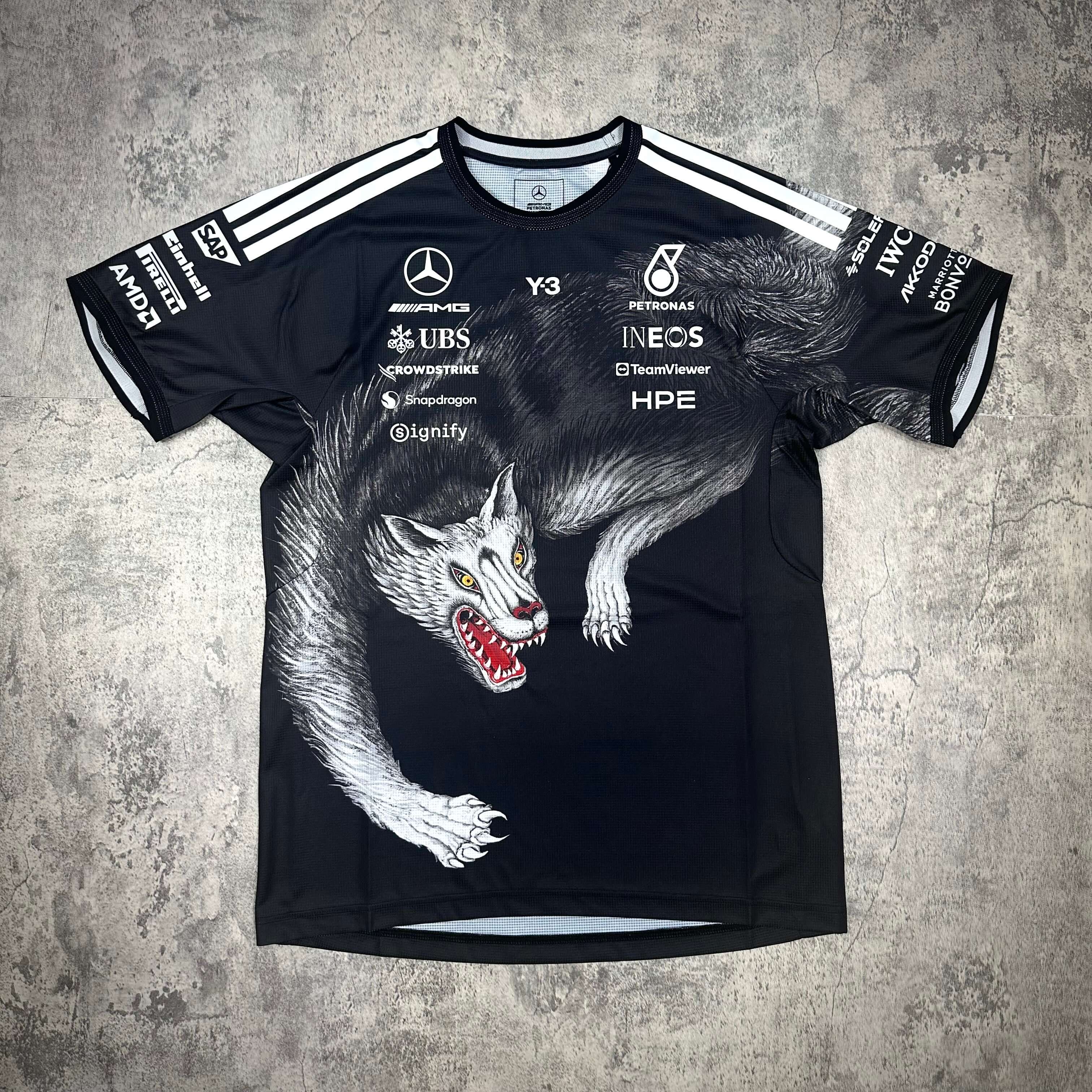 Y-3 x Mercedes AMG Petronas F1 Driver Jersey featuring a wolf graphic and sponsor logos on a black background.