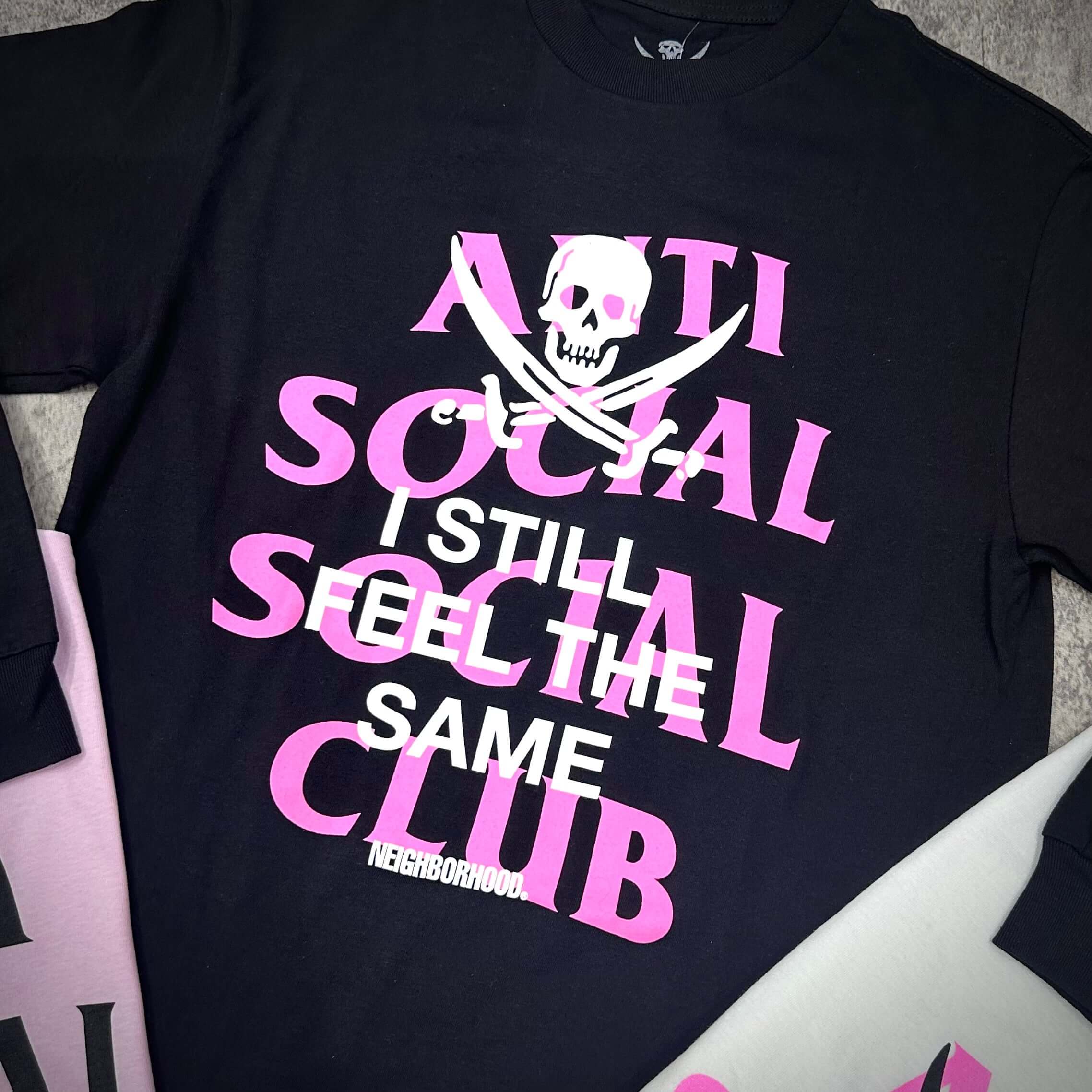 Close-up of the ASSC x Neighborhood Black Jack L/S Tee featuring bold text and pirate skull design.