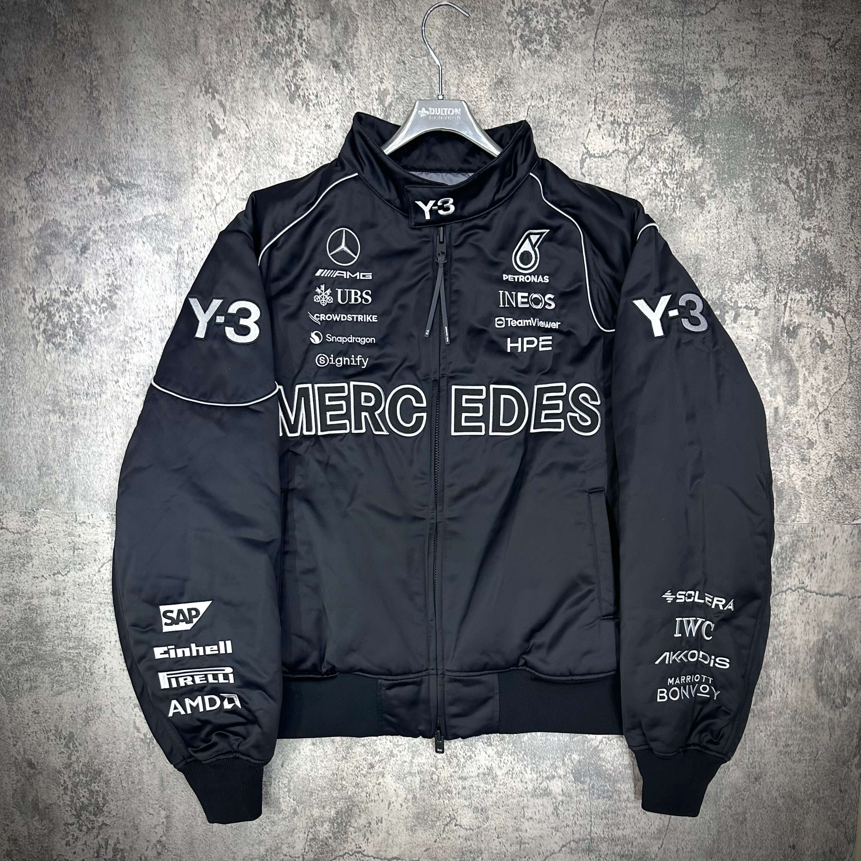 Y-3 x Mercedes AMG Petronas F1 Team Jacket featuring logo details and branding, black color, stylish design.