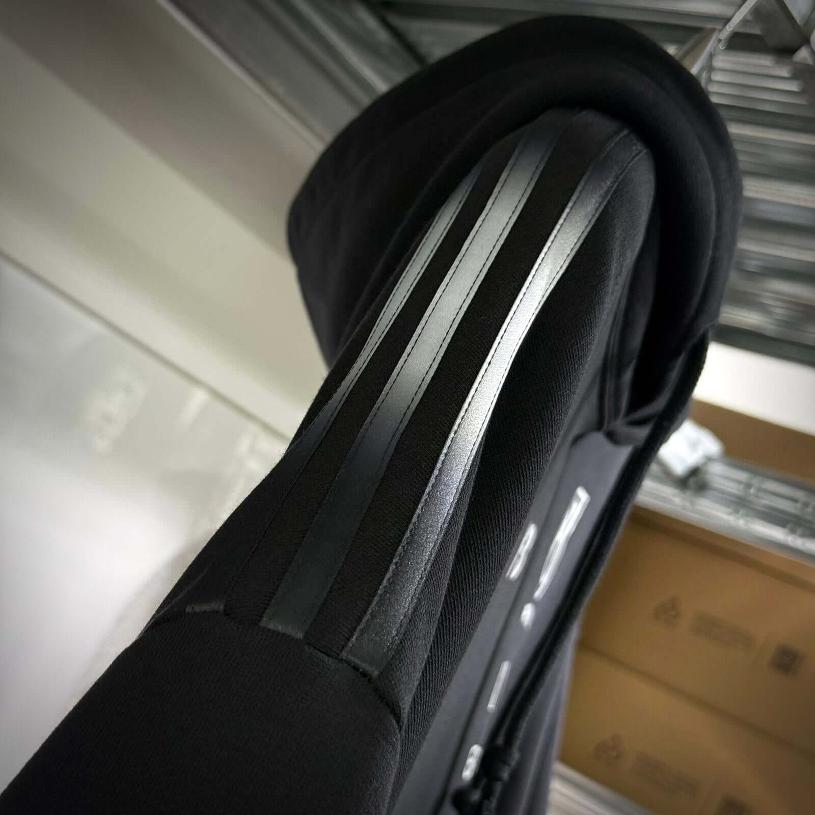 Close-up of Y-3 x Mercedes AMG Petronas F1 hoodie showing sleek black stripes on the sleeves.