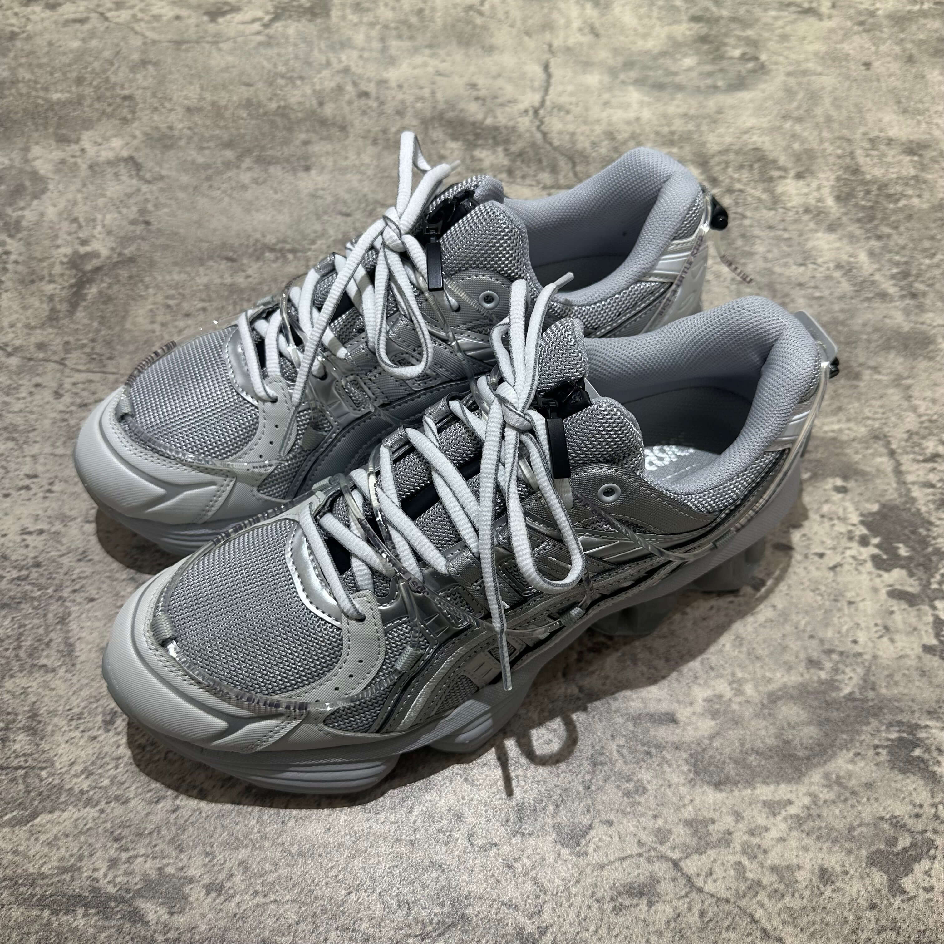 Yoasobi x Asics Gel Kinetic Fluent Y in Piedmont Grey and Pure Silver, showcasing a stylish athletic shoe design.