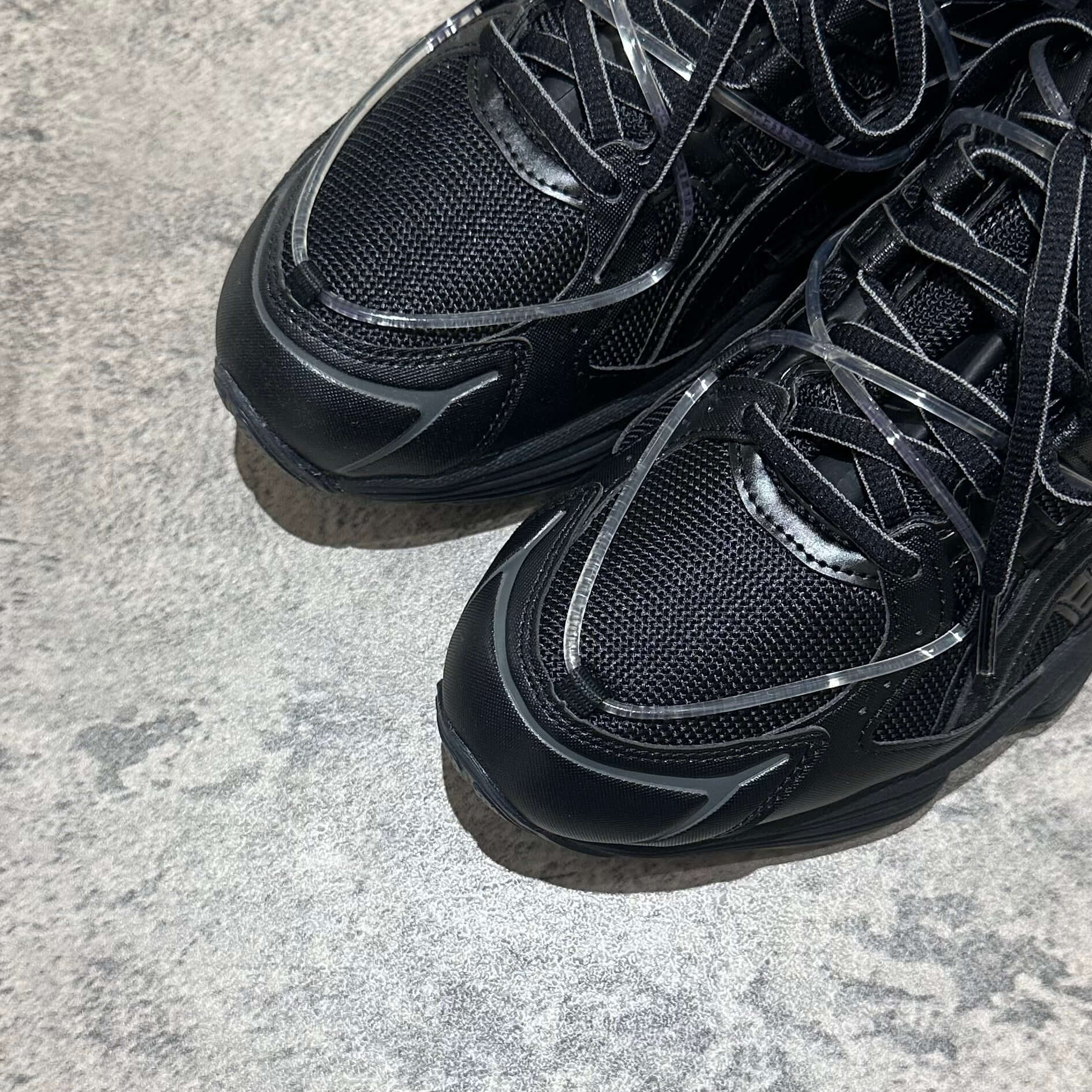 Yoasobi x Asics Gel Kinetic Fluent Y - Black close-up view of sneaker upper with lace details and textured surface.