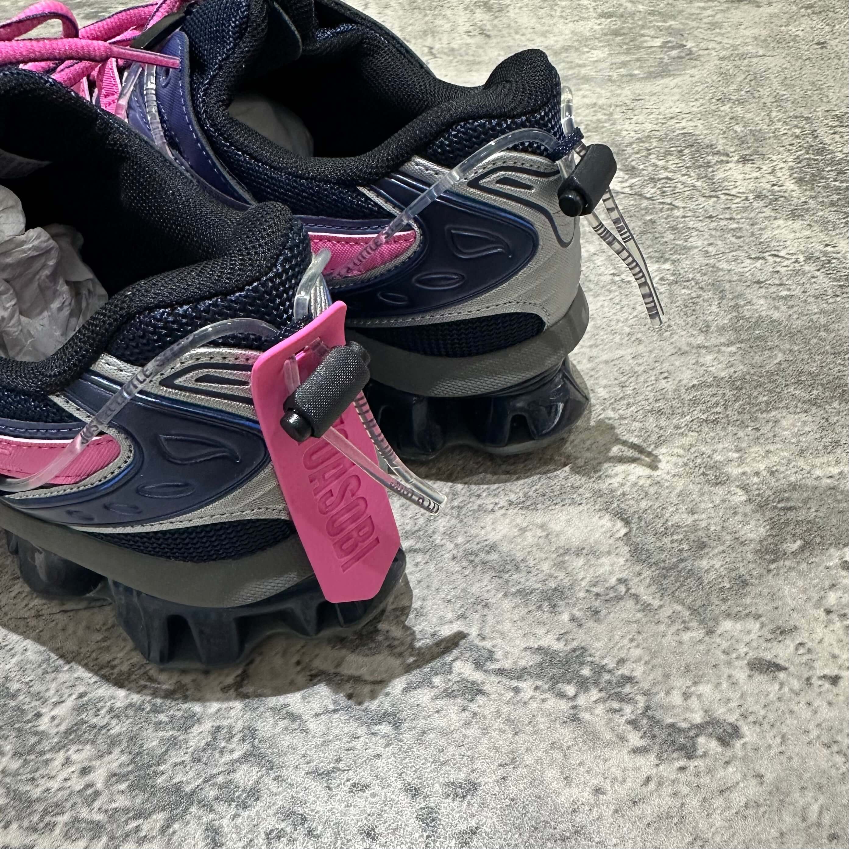 Yoasobi x Asics Gel Kinetic Fluent Y - Midnight / Dragon Fruit sneaker detail with pink tag.