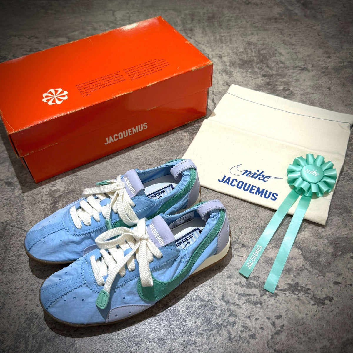 Jacquemus x Nike Moon Shoe SP - Emerald Rise HV8547-300 displayed with box and tote bag