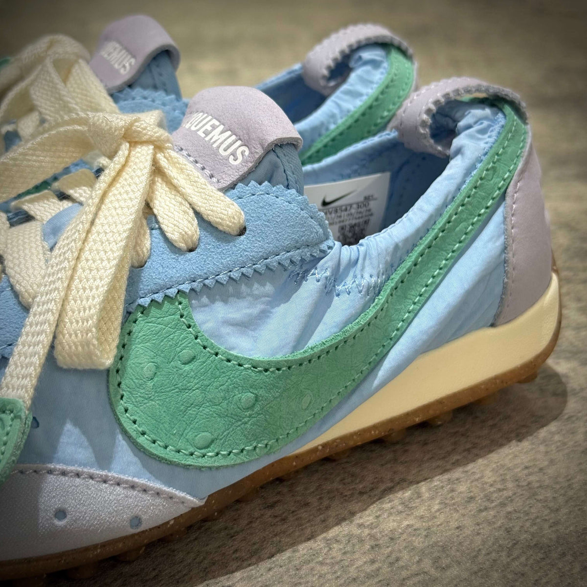 Jacquemus x Nike Moon Shoe SP - Emerald Rise HV8547-300 showing unique colorway with blue and green details.