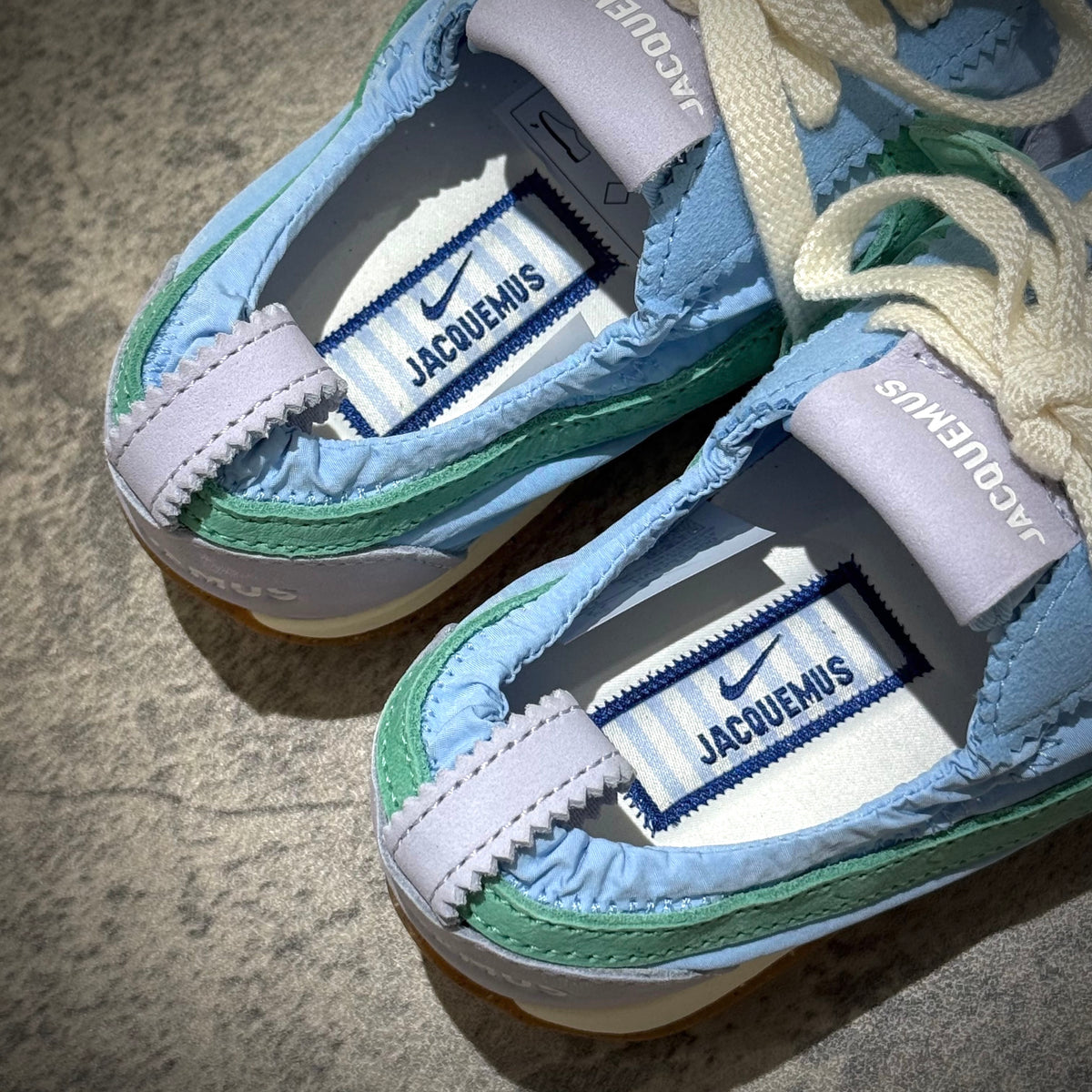 Jacquemus x Nike Moon Shoe SP - Emerald Rise HV8547-300 close-up view displaying the unique design and branding.