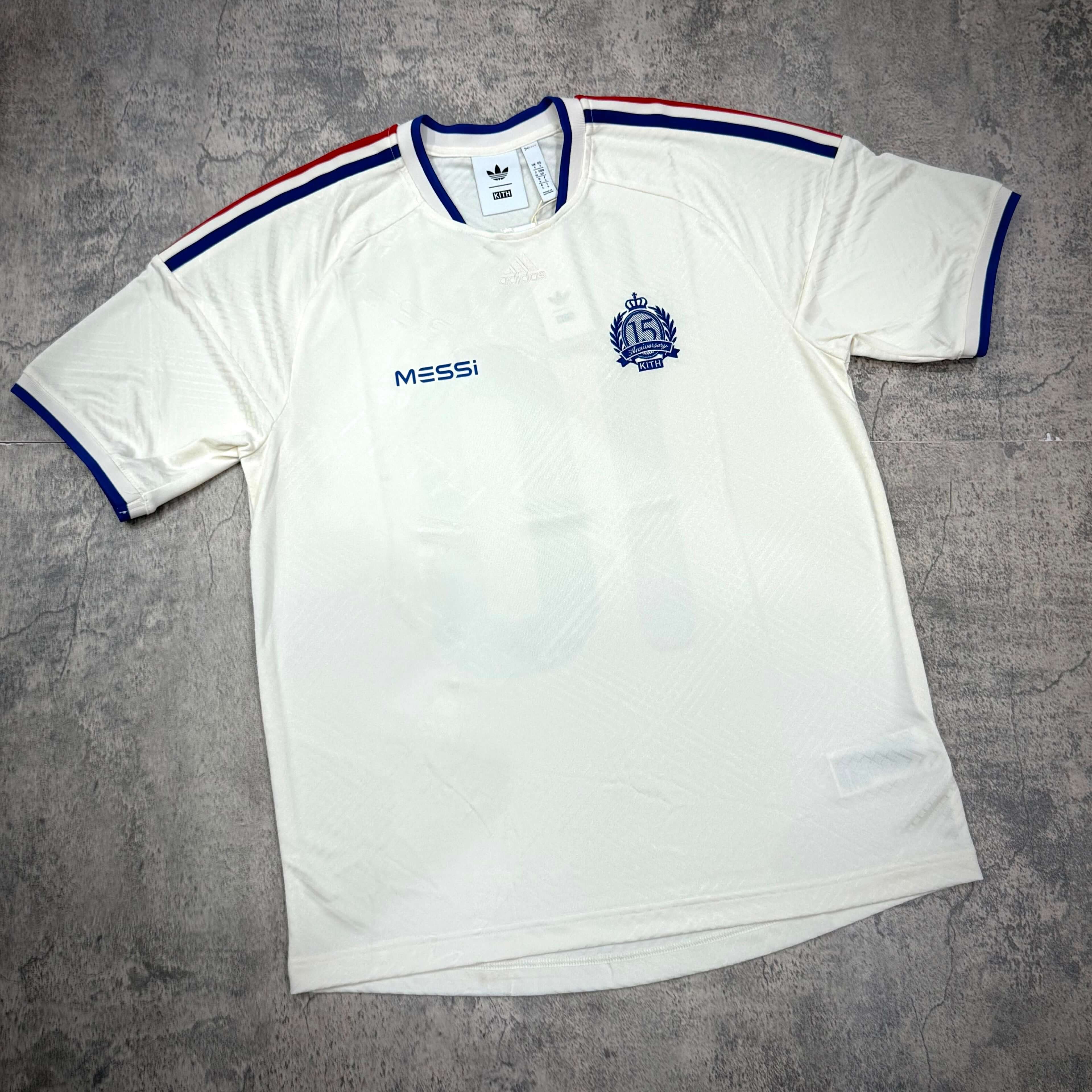 KITH x MESSI for adidas Football Jersey - Chalk White displayed on a textured background.