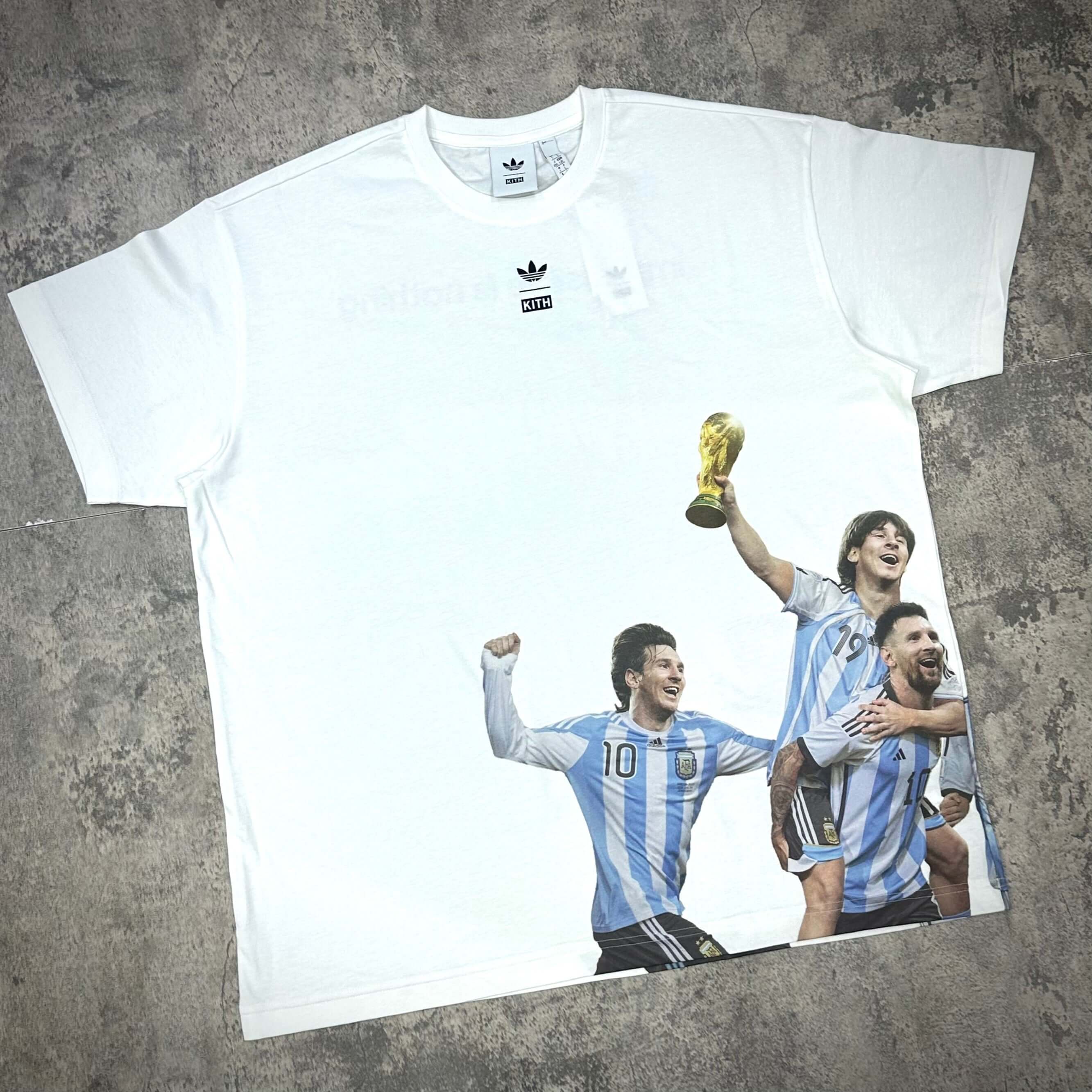 KITH x MESSI for adidas Football World Cup Tee displaying players celebrating with the World Cup trophy.