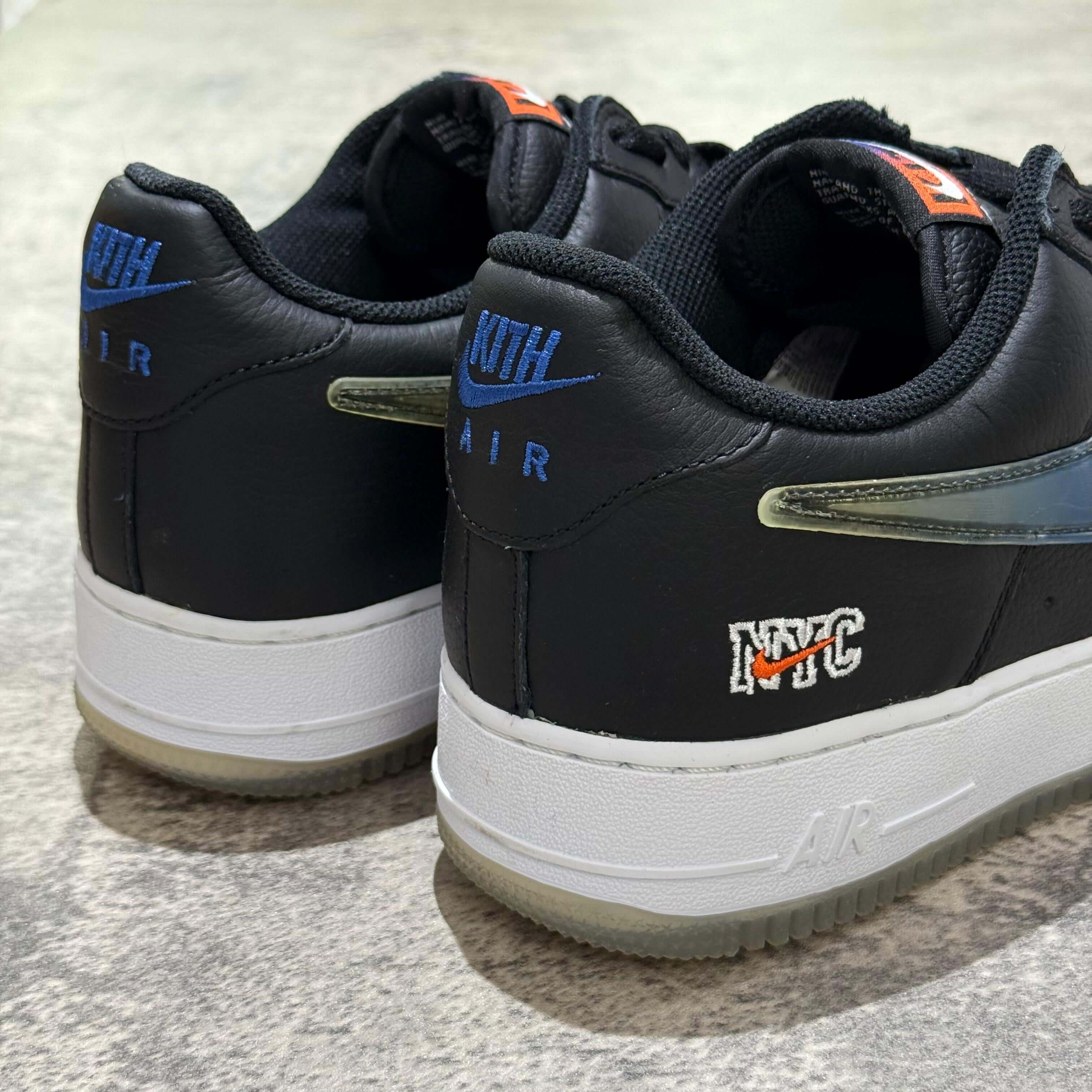 KITH x Nike Air Force 1 Low Knicks rear view showcasing black leather design with NYC embroidery and blue accents.