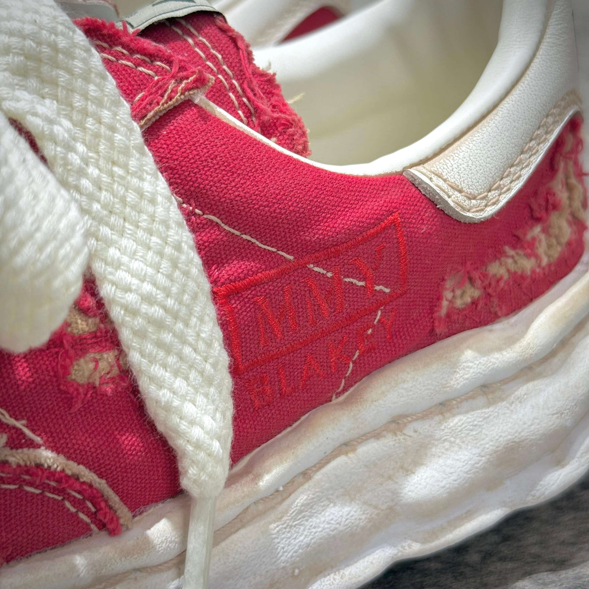 Close-up of MMY Blakey Canvas Ripped Overdye Low - Red A16FW729 showcasing details and texture.