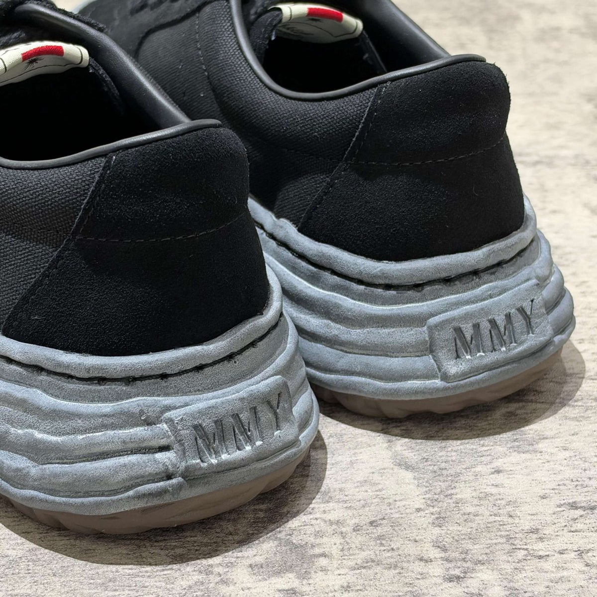 MMY Eric Overdyed Canvas - All Black sneaker rear view showcasing logo and unique sole design