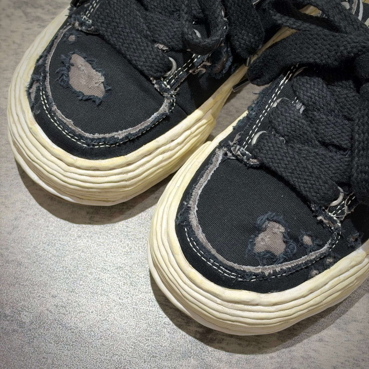 MMY Oliver Ripping Canvas Low - Black showing distressed details and worn look on black canvas sneakers.