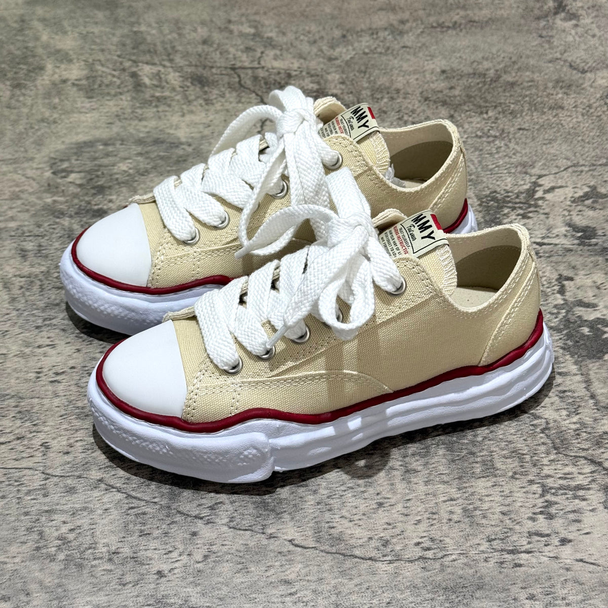 MMY PETERSON OG Canvas - Natural oversized sneakers with white laces, beige fabric, and contrasting red sole.