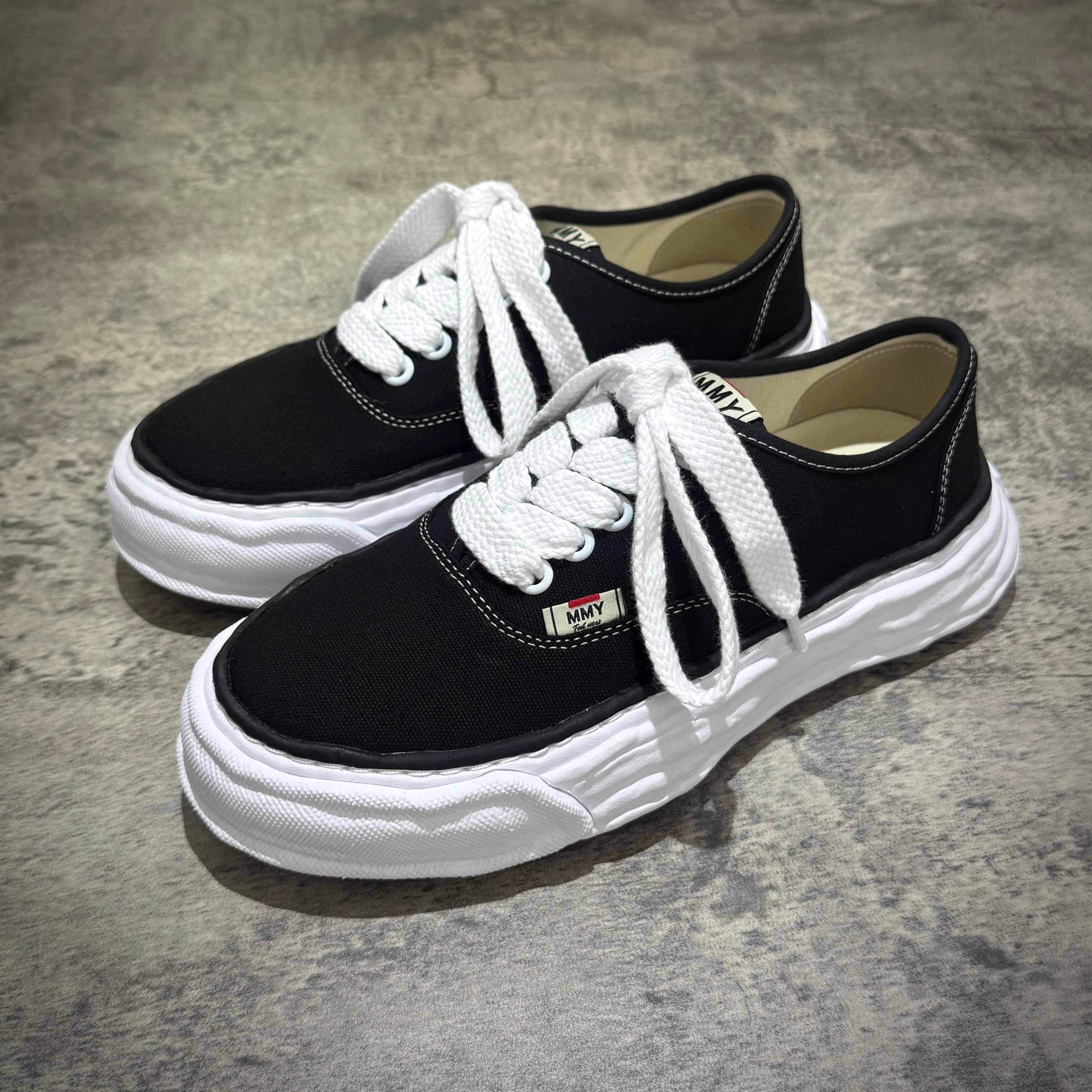 MMY Baker26 Canvas Low - Black sneakers with white laces and sole, stylish casual footwear for everyday wear.