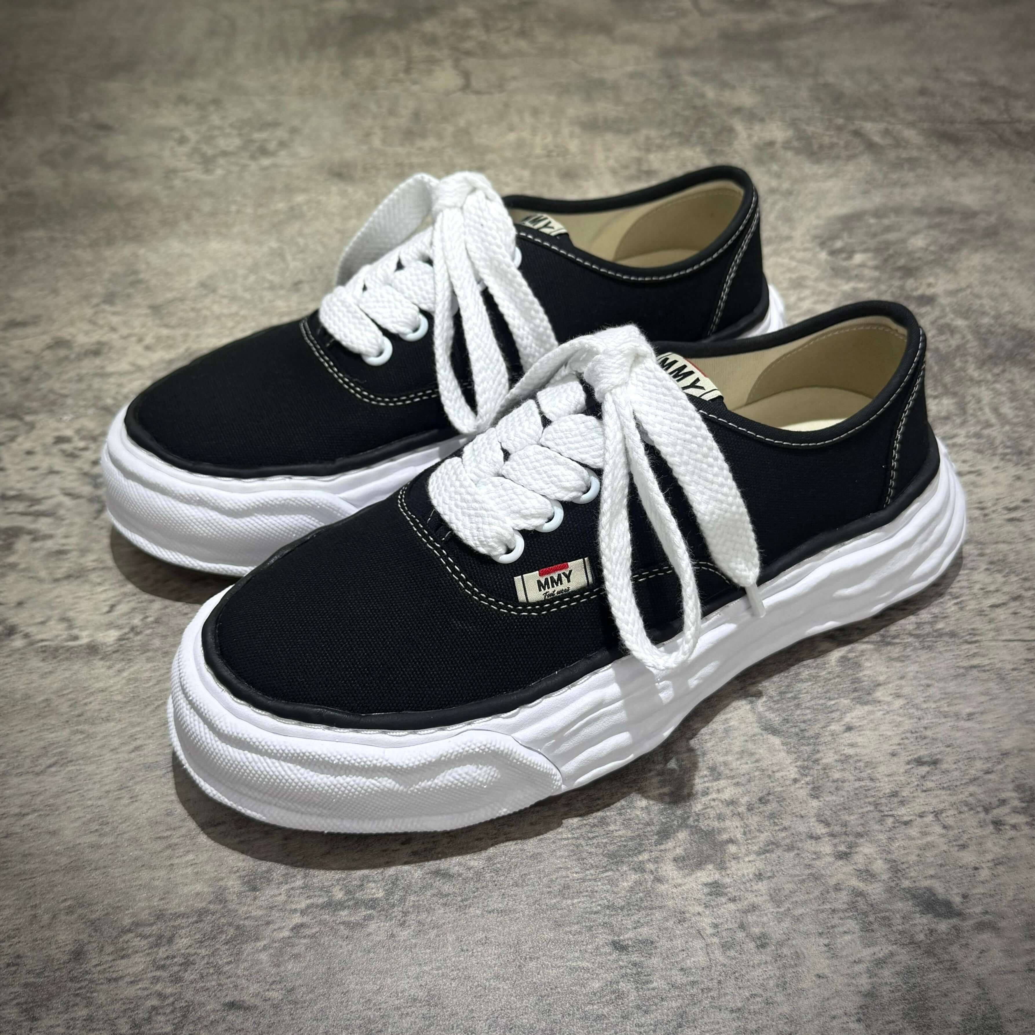 MMY Baker26 Canvas Low - Black sneakers with white laces and sole, stylish casual footwear for everyday wear.