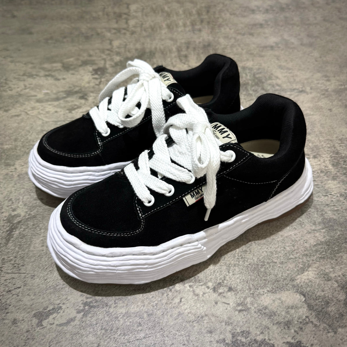 MMY Oliver Suede Low - Black shoes featuring a stylish black suede design with white details and laces.