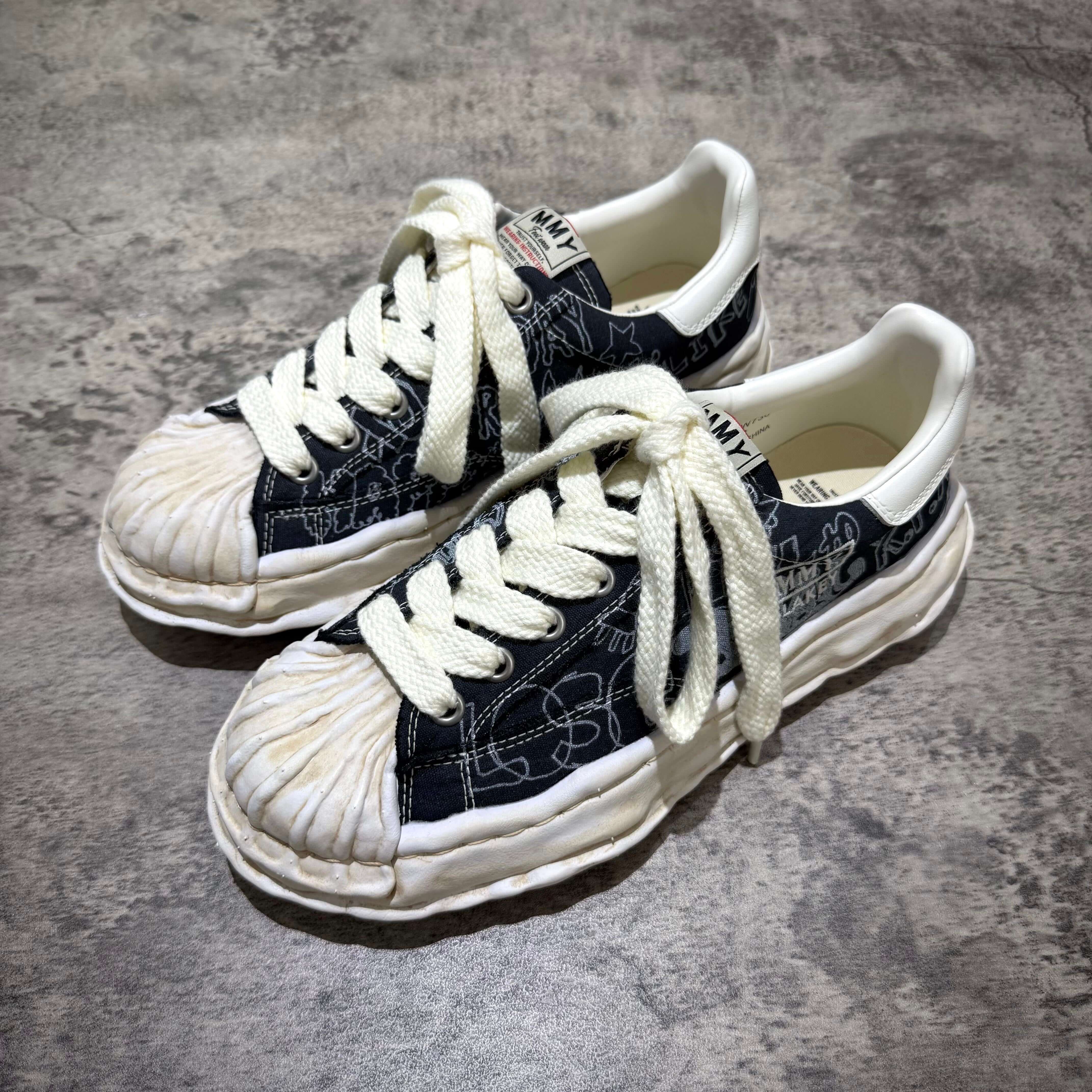 MMY BLAKEY Graffiti Printed Canvas Low sneaker with white laces and unique printed design on a grey background.