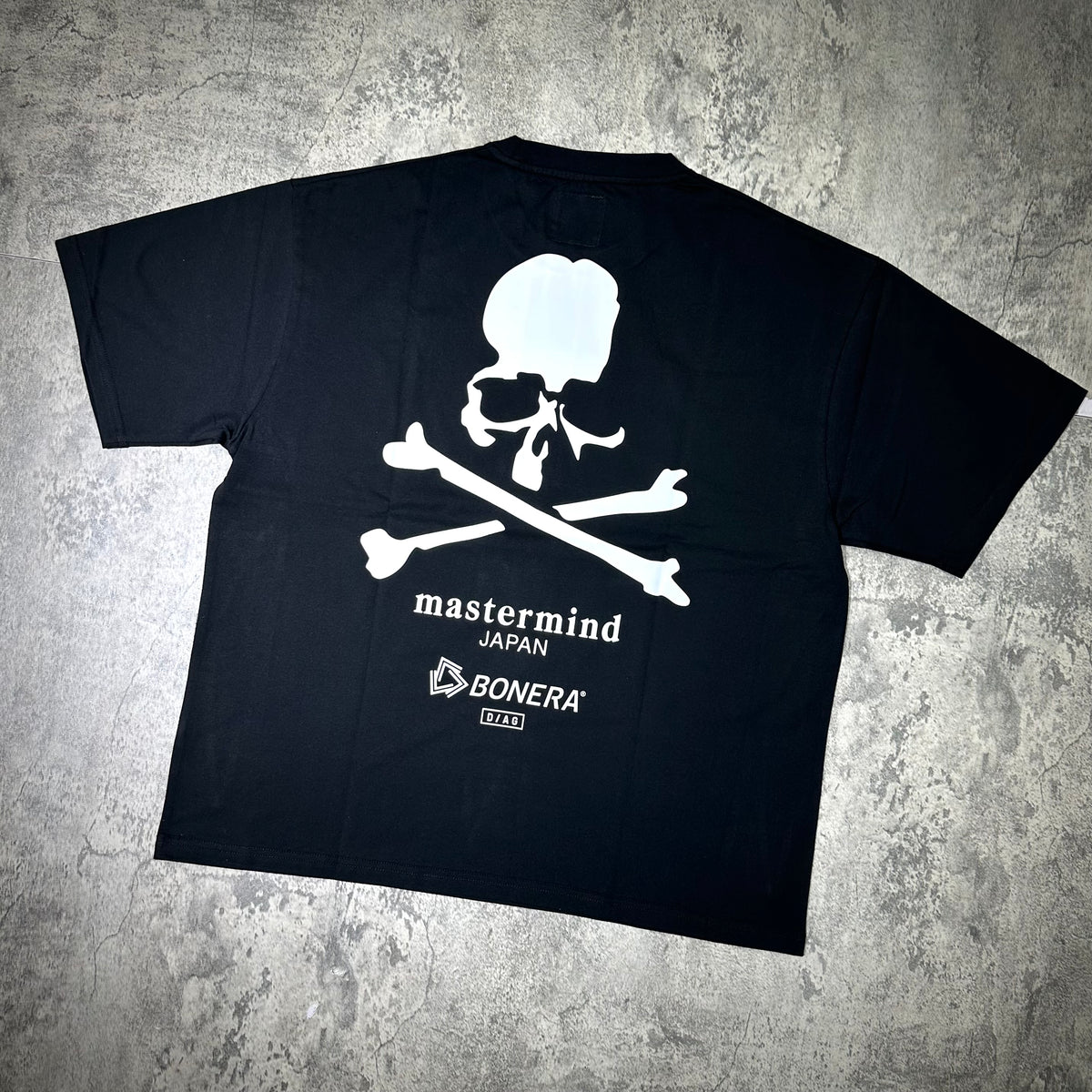 Mastermind Japan x Bonera Tee, black t-shirt featuring skull and crossbones design on back.