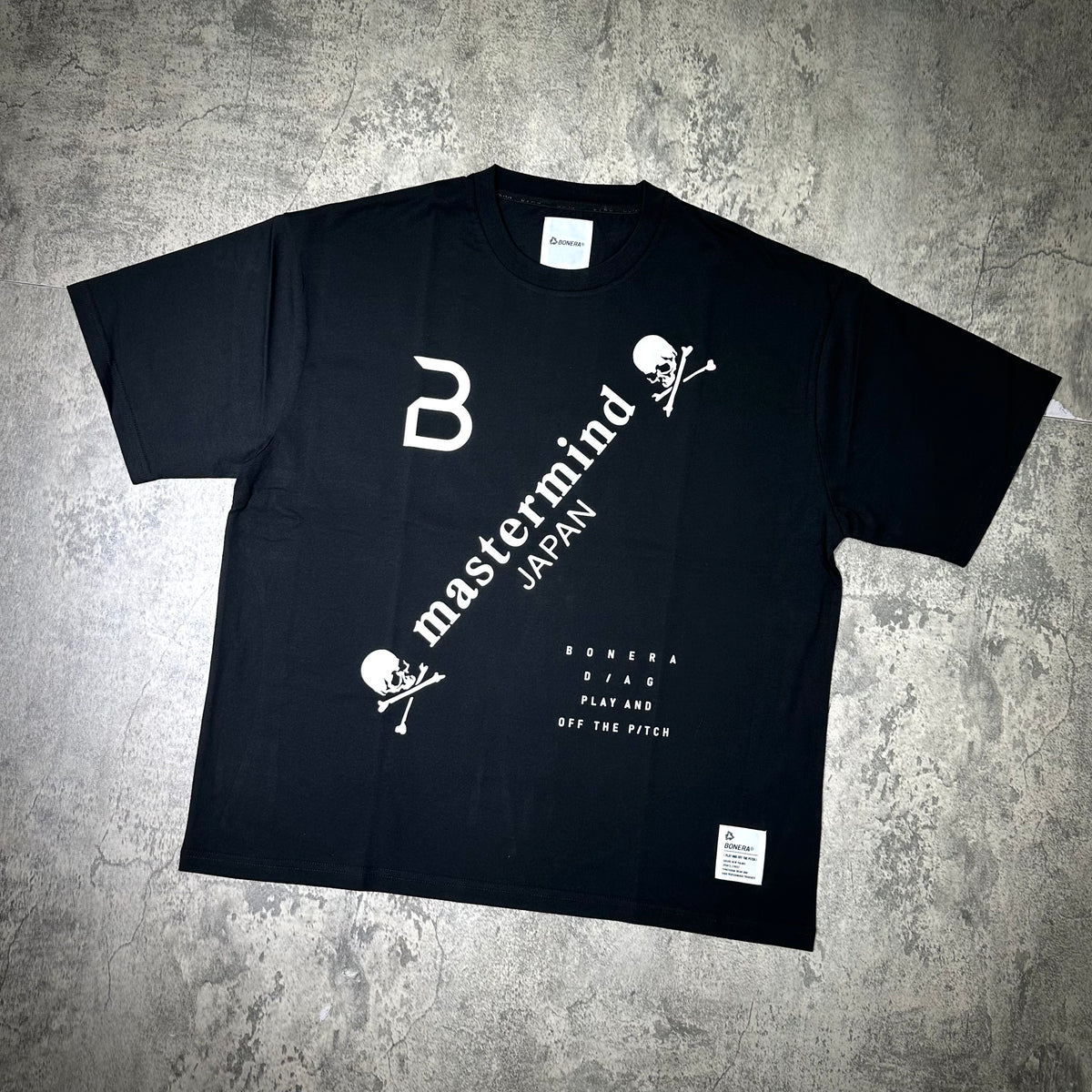 Mastermind Japan x Bonera Tee featuring a black design with white graphics and logo details on the front.