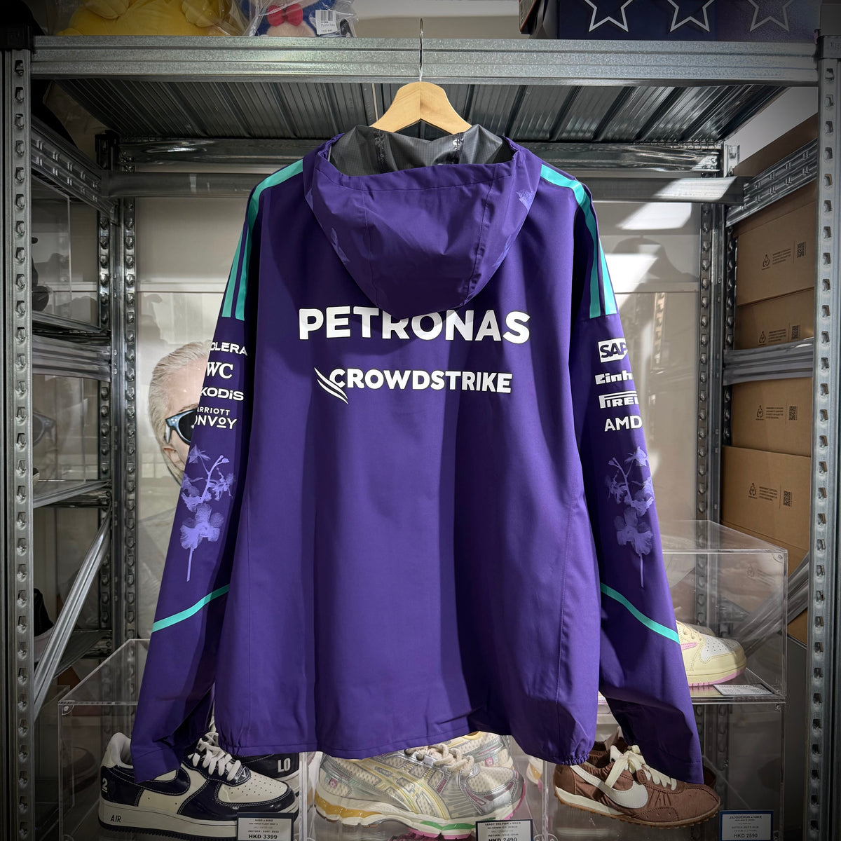 Mercedes-AMG Petronas Formula 1 Team Vanda Bloom Rain Jacket HZ9485 displayed from the back in purple with PETRONAS and CROWDSTRIKE branding.